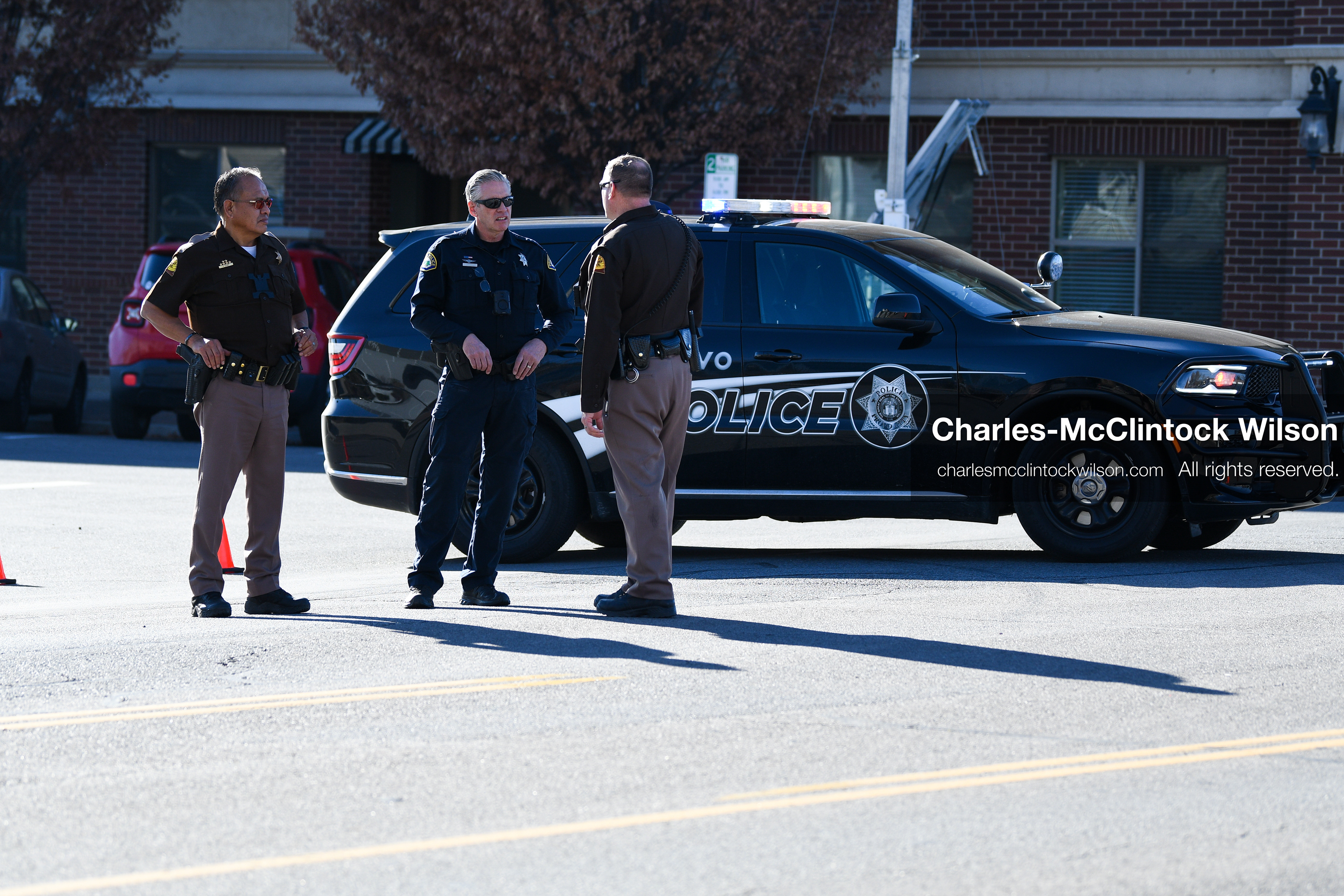 PROVO, UTAH, USA – DECEMBER 11, 2025: Two Utah Highway Patrol officers and a Provo Police officer converse outside the Fourth District Court in Provo during the first in‑person court appearance of Tyler Robinson in the Charlie Kirk murder case. (Credit Image: © Charles‑McClintock Wilson/ZUMA Press Wire)