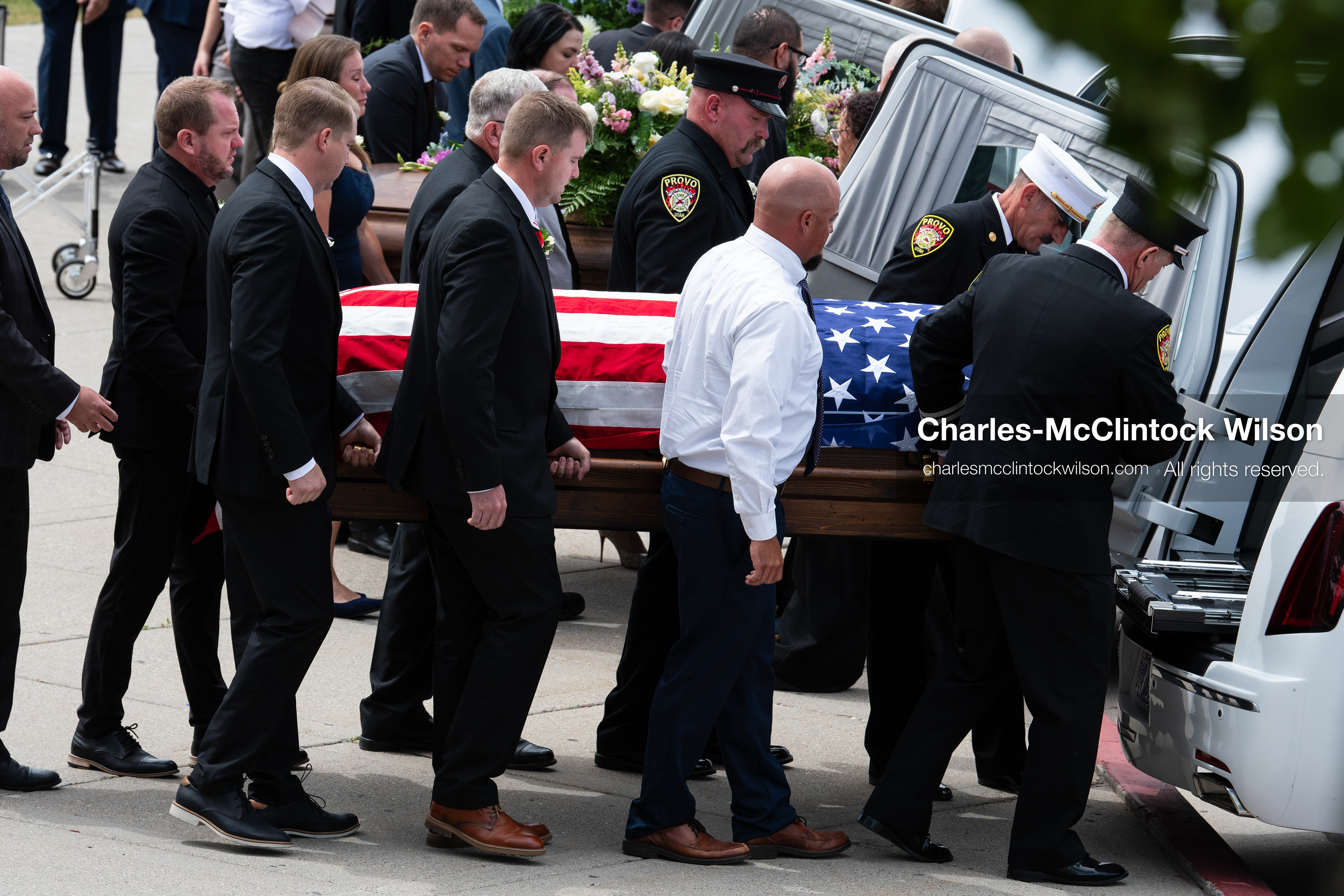 Firefighters and pallbearers load the flag-draped casket of Provo Fire Captain Spencer Long into a white hearse outside the UCCU Center at Utah Valley University in Orem, Utah, on Wednesday, July 29, 2026. More than 300 people came to the public memorial ceremony to honor Captain Long, his wife Katrina, and three of their sons, who died after a flash flood hit their campsite near the Sunglow Campground in Wayne County. (Photo by Charles-McClintock Wilson/Sipa USA)