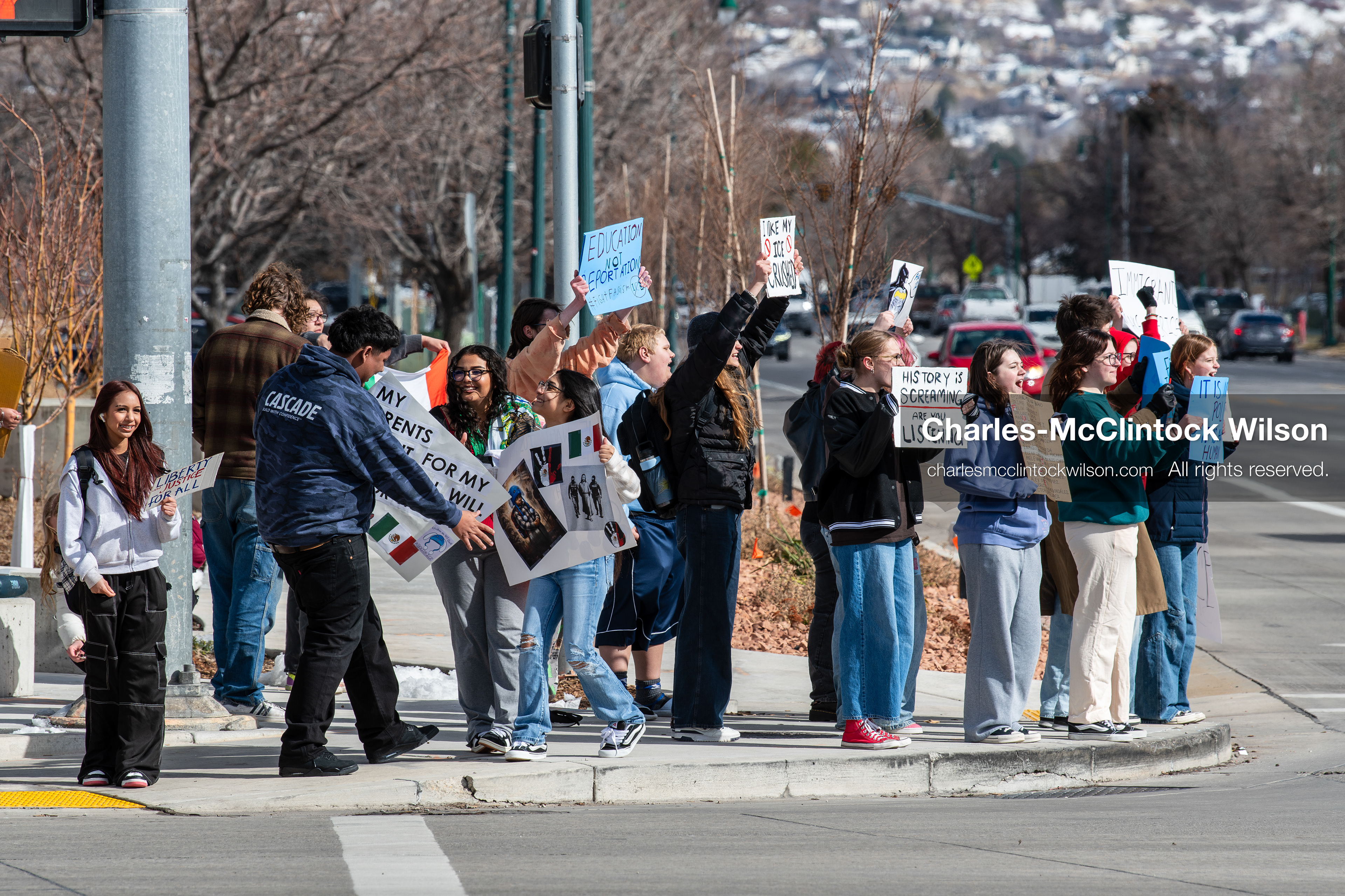 February 20, 2026, Orem, Utah, USA: High school students gather along State Street in front of Orem City Hall during a student led protest against ICE and federal immigration enforcement. Demonstrators hold signs as they stand near the roadway while traffic continues through the area. (Credit Image: © Charles McClintock Wilson/ZUMA Press Wire)