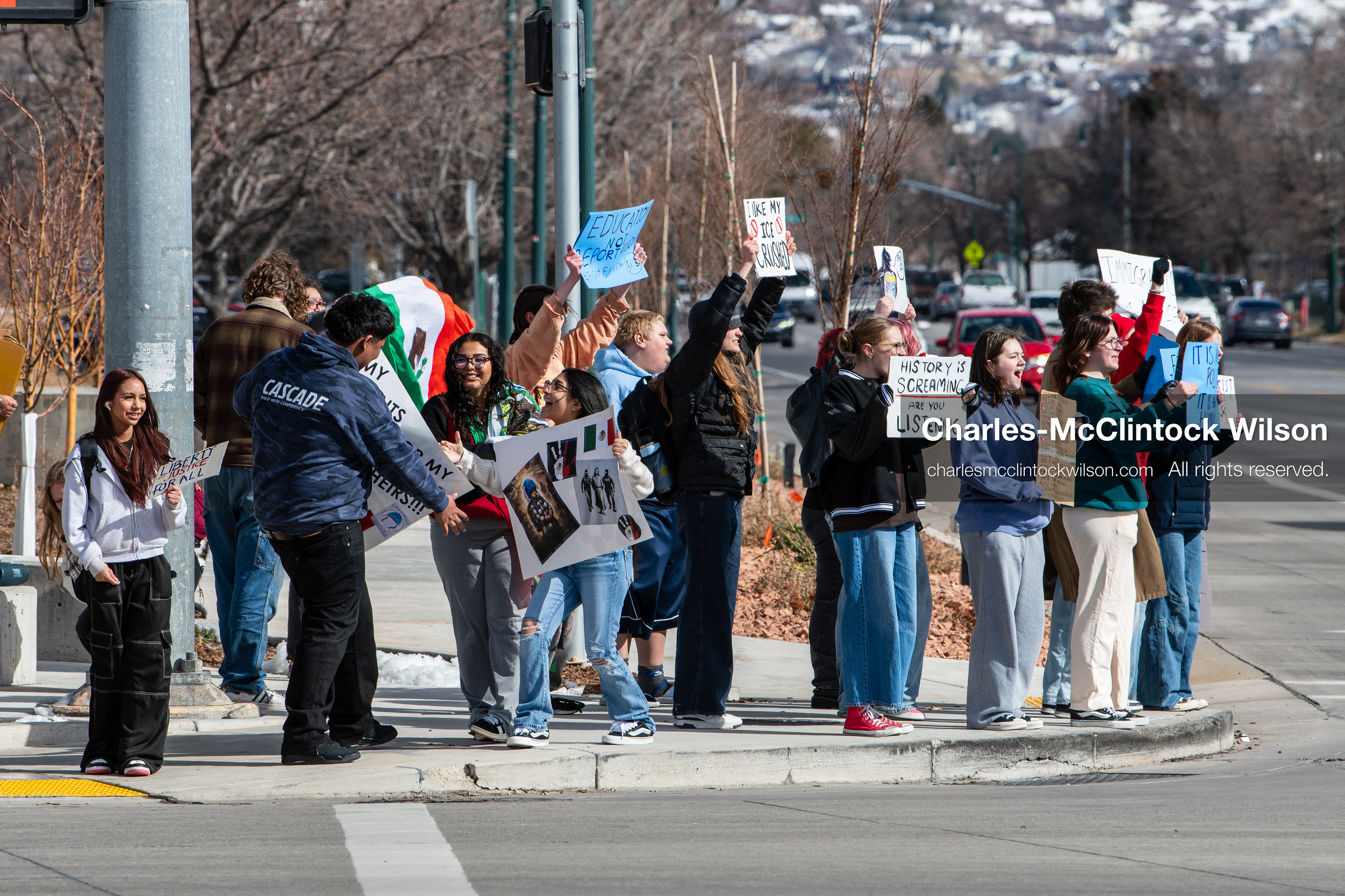 February 20, 2026, Orem, Utah, USA: High school students gather along State Street in front of Orem City Hall during a student led protest against ICE and federal immigration enforcement. Demonstrators hold signs as they stand near the roadway while traffic continues through the area. (Credit Image: © Charles McClintock Wilson/ZUMA Press Wire)