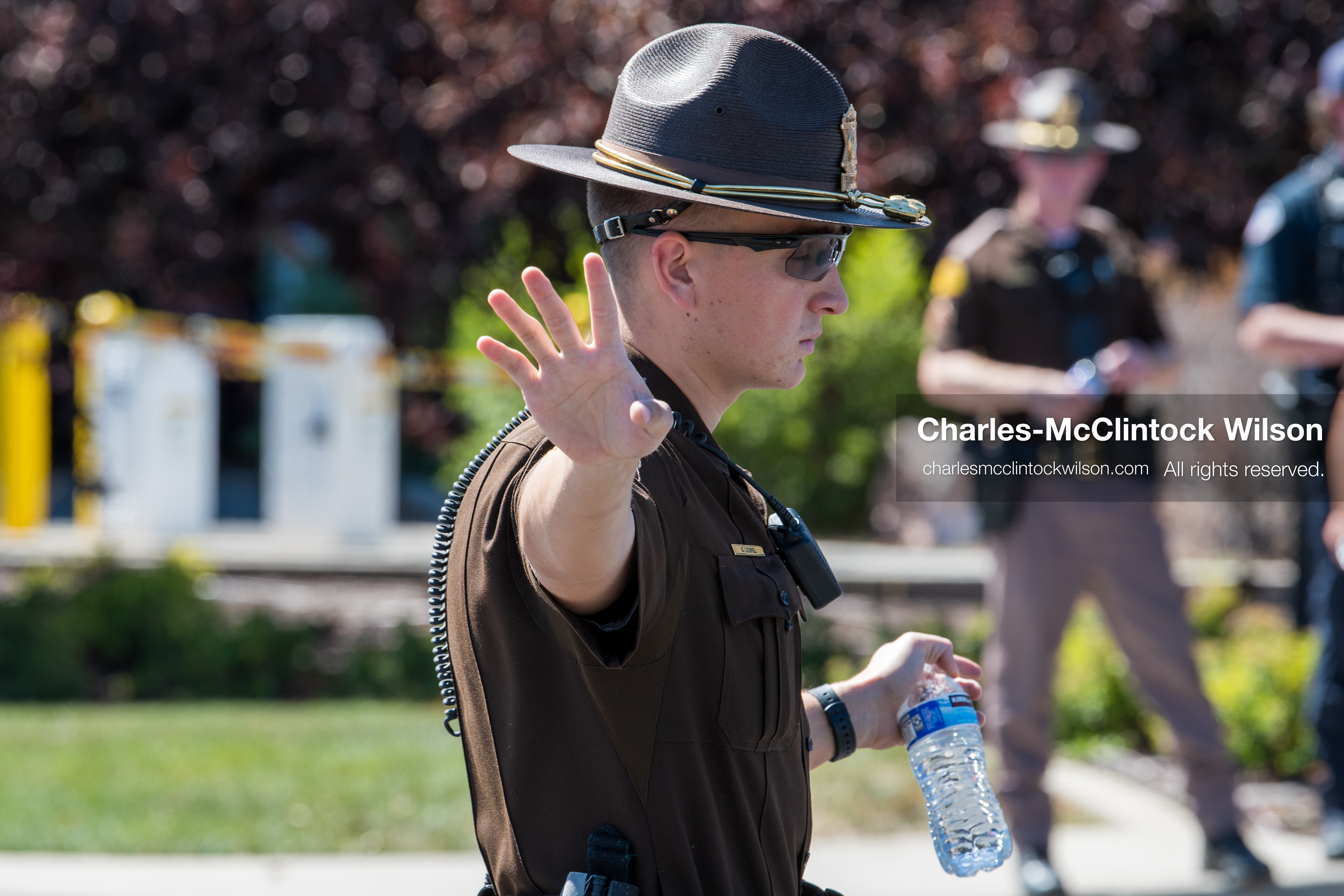 A Utah Highway Patrol trooper directs traffic outside Intermountain Medical Center in Murray, Utah, United States, on August 17, 2026. Regional police agencies secured the hospital perimeter after shooting victims were admitted following a fatal shootout outside a funeral service in nearby Kearns. (Photo by Charles-McClintock Wilson/NurPhoto)