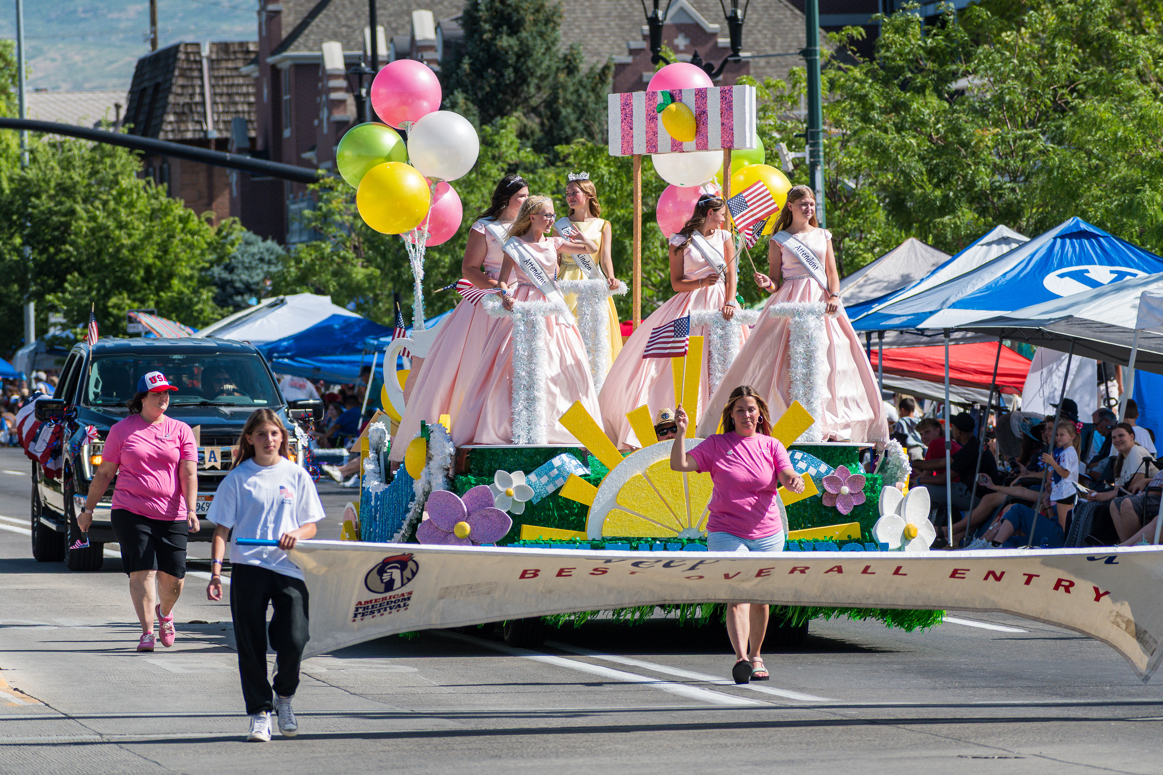 Provo, Utah – July 4, 2025: Miss Little Lindon and her attendants ride on a decorated float during the Freedom Festival Grand Parade in downtown Provo.