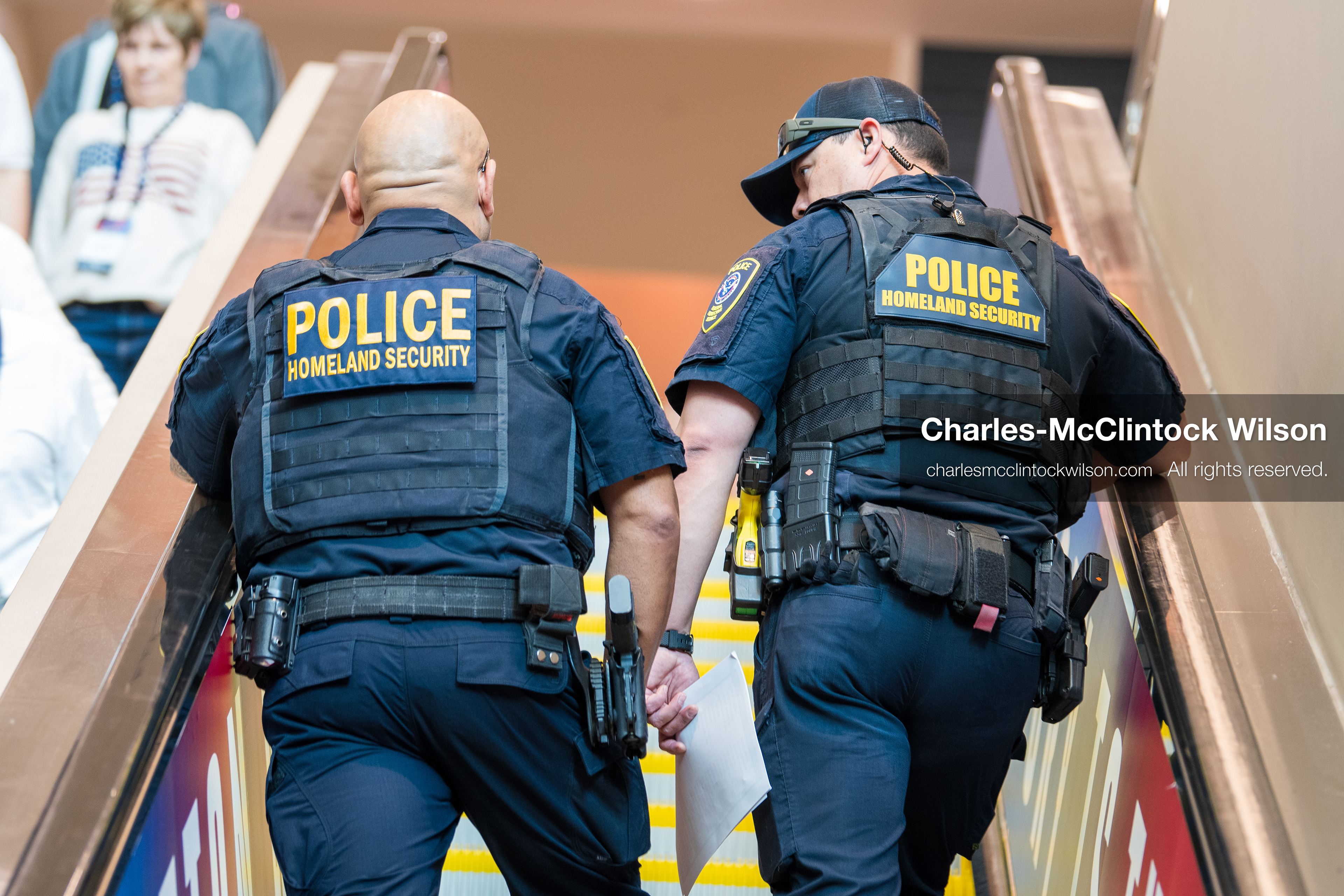 December 18, 2025, Phoenix, Arizona, USA: Two U.S. Department of Homeland Security officers ride an escalator during AmericaFest 2025 at the Phoenix Convention Center, the first edition of the event held since the death of Charlie Kirk. (Credit Image: (c) Charles-McClintock Wilson/ZUMA Press Wire)