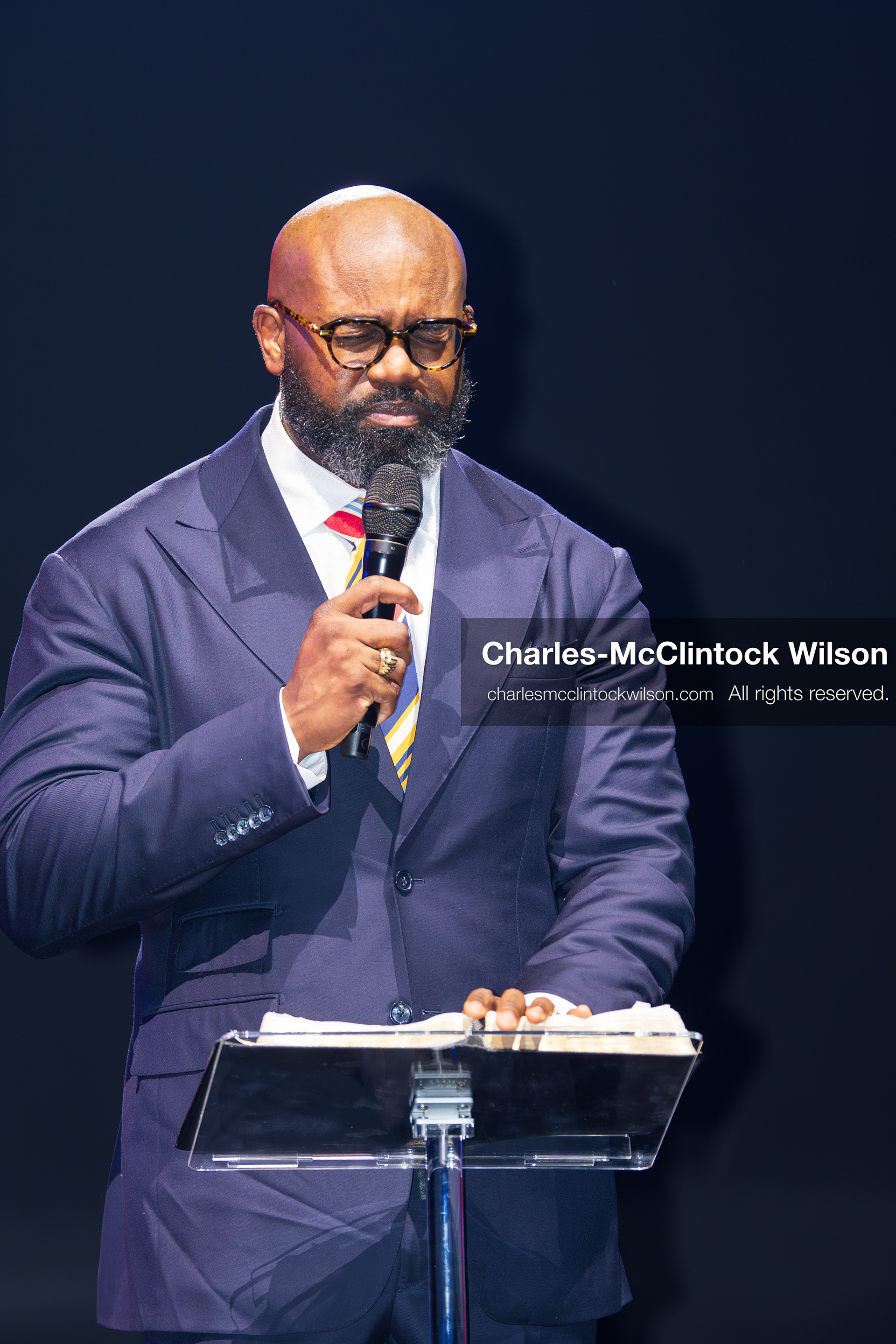December 18, 2025, Phoenix, Arizona, USA: Pastor John Amanchukwu speaks on stage during AmericaFest 2025 at the Phoenix Convention Center, holding a microphone behind a transparent podium. (Credit Image: (c) Charles-McClintock Wilson/ZUMA Press Wire)
