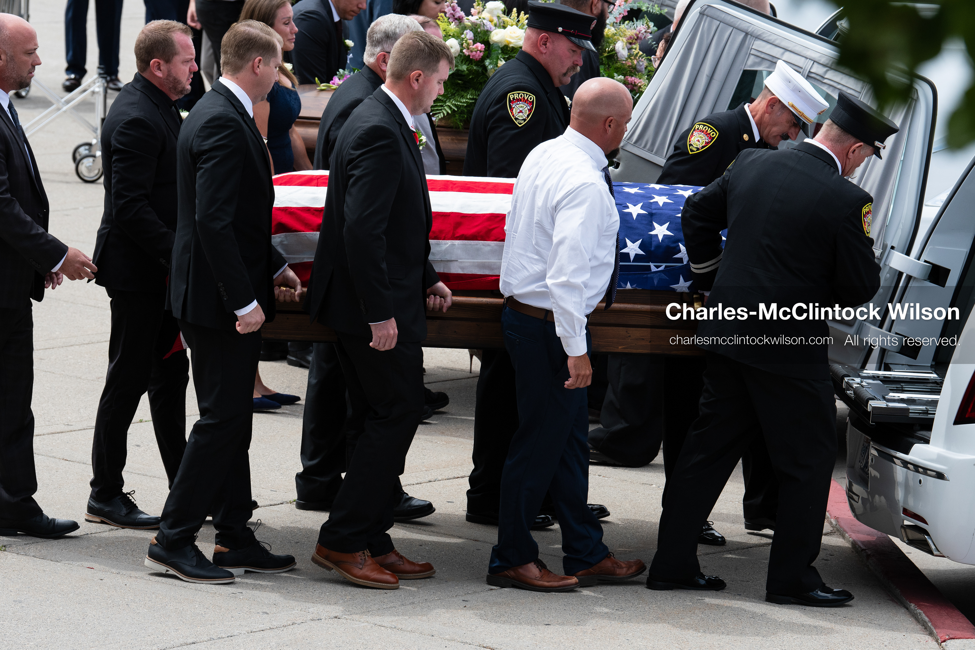 Firefighters and pallbearers load the flag-draped casket of Provo Fire Captain Spencer Long into a white hearse outside the UCCU Center at Utah Valley University in Orem, Utah, on Wednesday, July 29, 2026. More than 300 people came to the public memorial ceremony to honor Captain Long, his wife Katrina, and three of their sons, who died after a flash flood hit their campsite near the Sunglow Campground in Wayne County. (Photo by Charles-McClintock Wilson/Sipa USA)