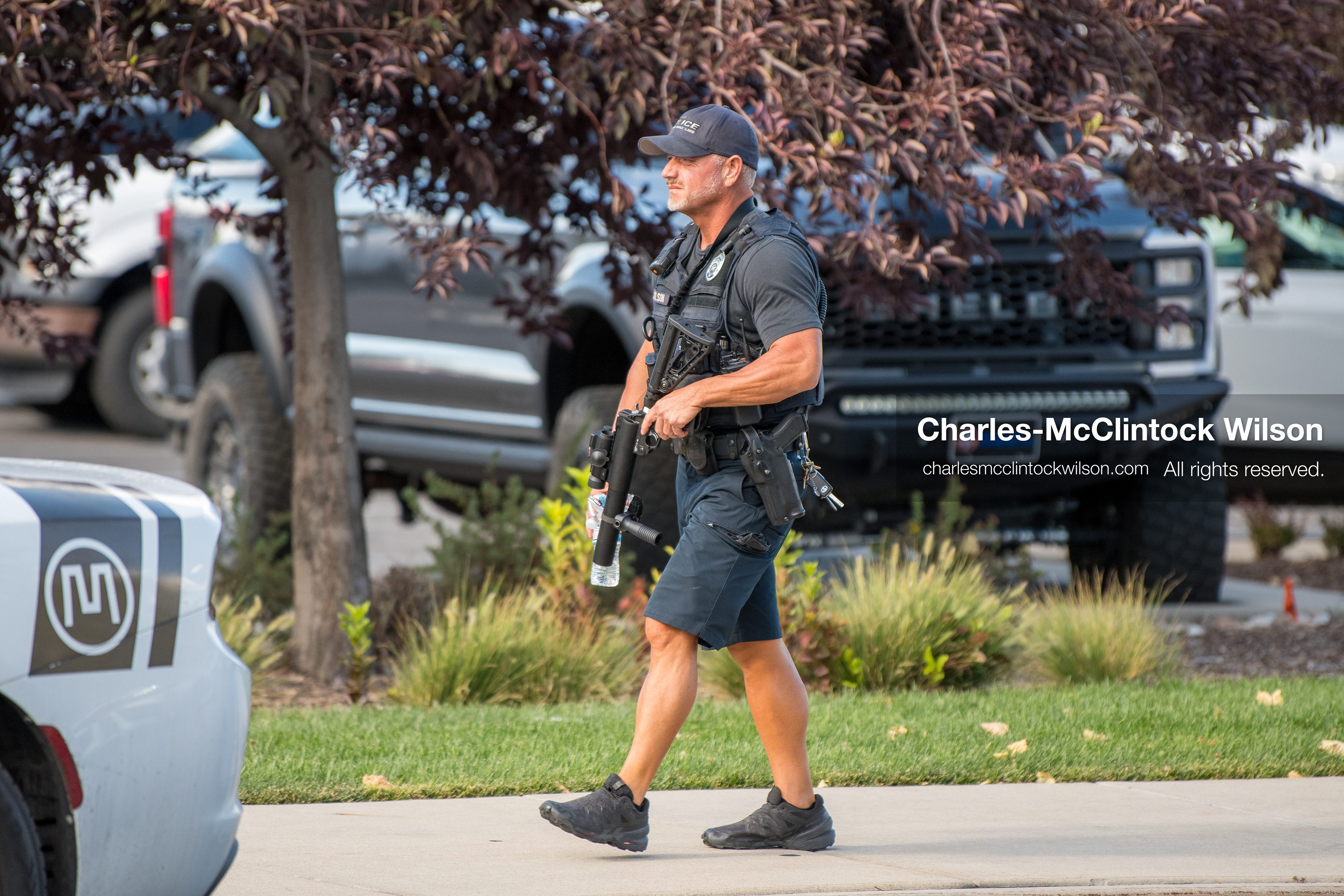 An armed plainclothes law enforcement investigator patrols a sidewalk perimeter outside Intermountain Medical Center in Murray, Utah, on Monday, August 17, 2026. Multiple regional law enforcement agencies converged to heavily secure the hospital perimeter as a safety precaution after shooting victims arrived from a fatal shootout that erupted outside a funeral service in nearby Kearns earlier that day. (Photo by Charles-McClintock Wilson/Sipa USA)
