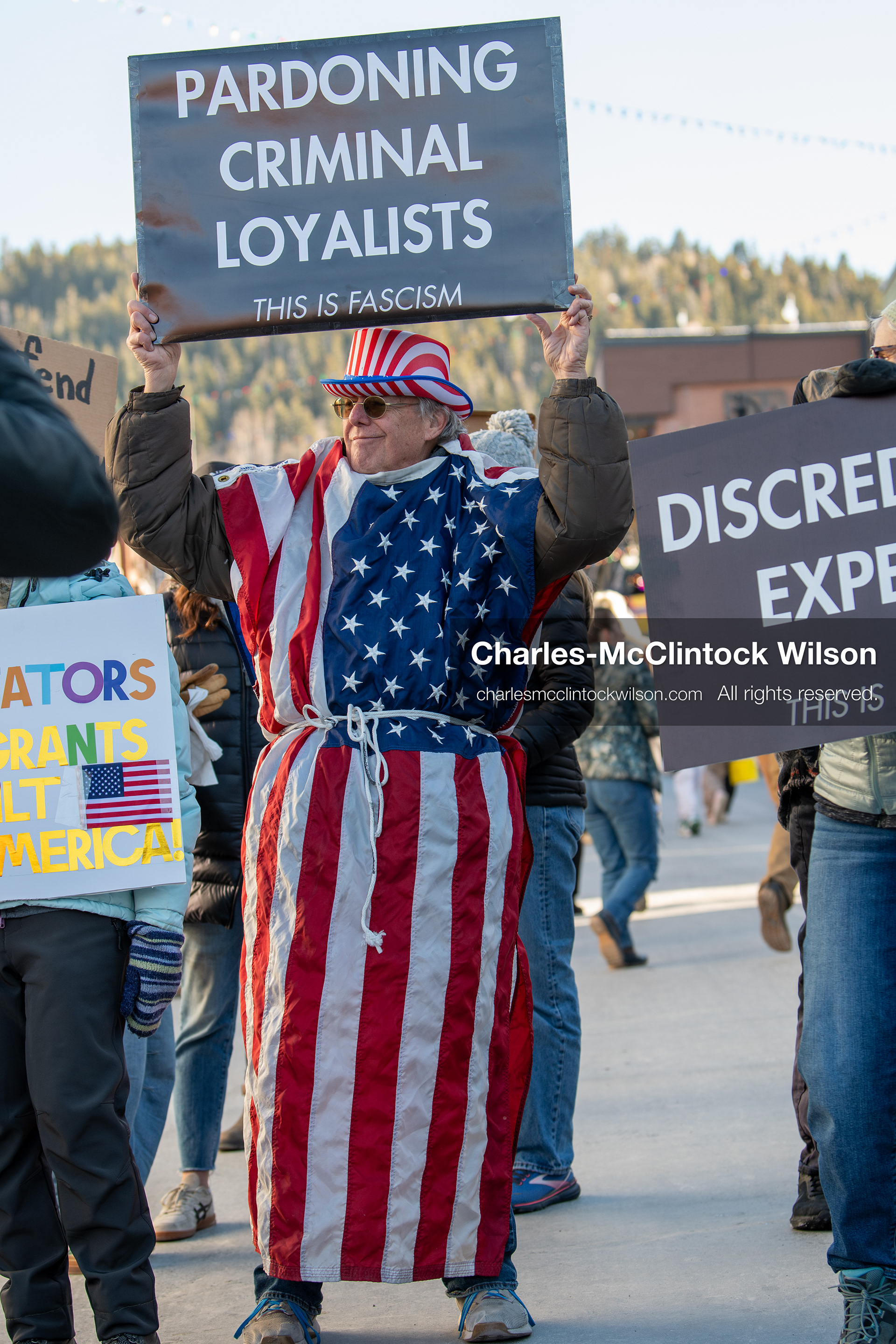 January 26, 2026, Park City, Utah, USA: A demonstrator dressed in an American flag-themed outfit holds a sign while participating in a protest opposing U.S. Immigration and Customs Enforcement (I.C.E.) ICE agents at the Sundance Film Festival in Park City, Utah, on Monday, Jan. 26, 2026. The event was held in response to the fatal shooting of Alex Pretti by a U.S. Border Patrol officer in Minneapolis. (Credit Image: © Charles McClintock Wilson/ZUMA Press Wire)