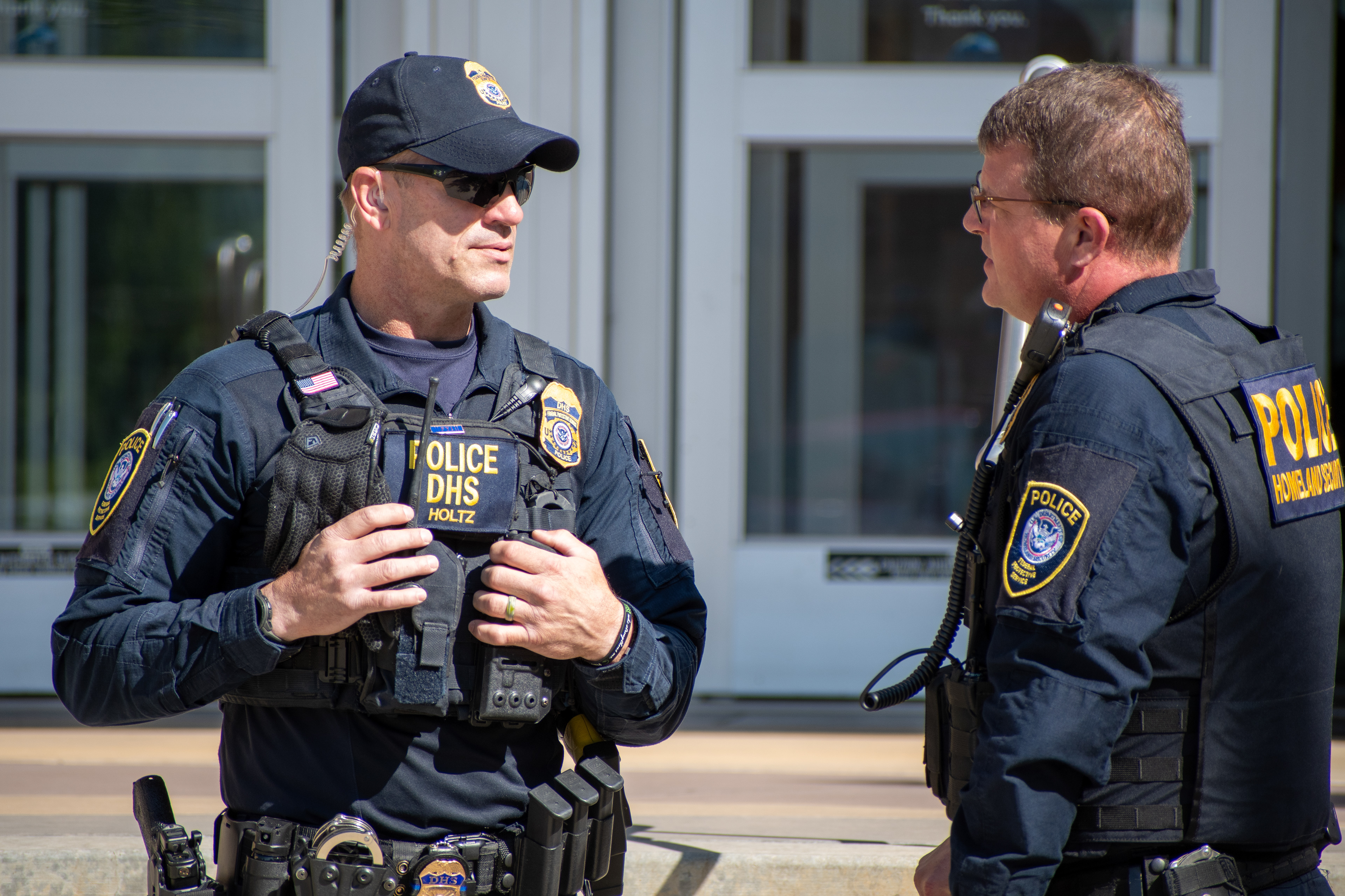 September 15, 2025 – Provo, Utah, United States: Two Homeland Security police officers speak outside the Utah Valley Convention Center during a Department of Homeland Security career expo, part of a national recruitment initiative offering federal law enforcement and security positions. Photograph by Charles‑McClintock Wilson / ZUMA Press Wire