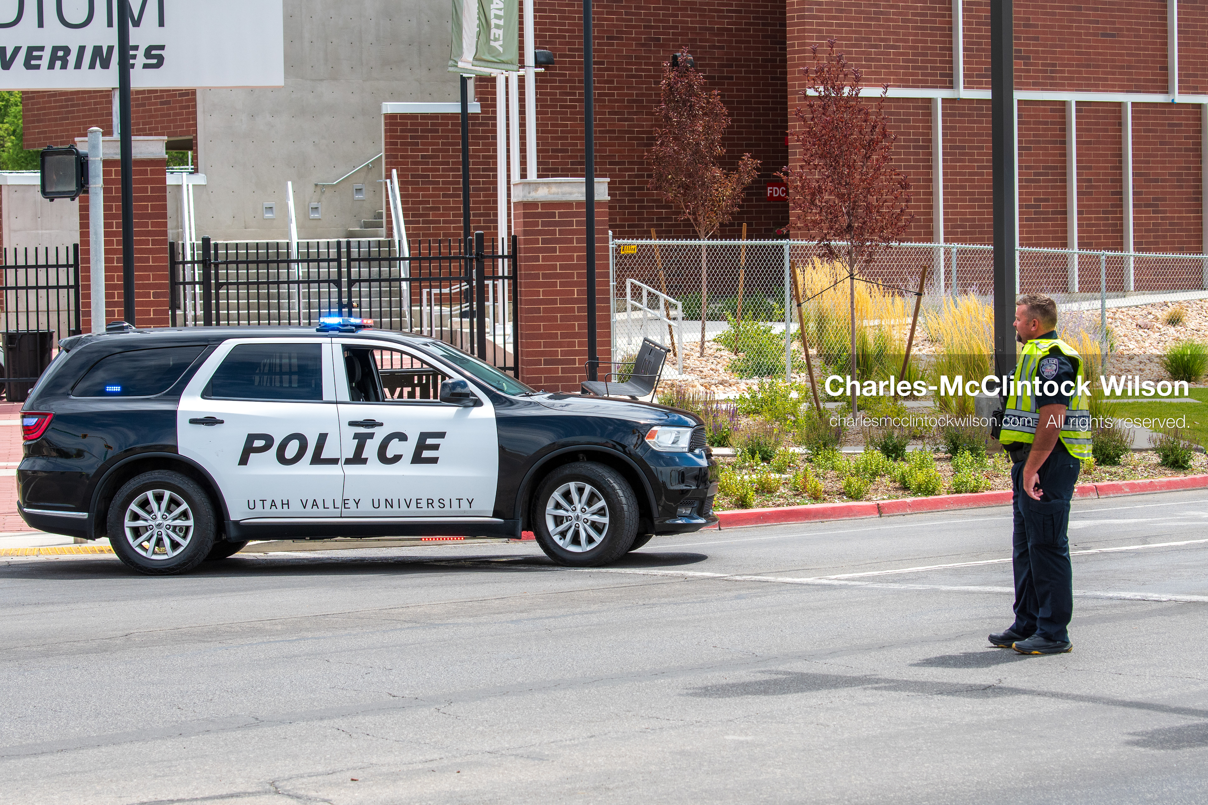 A traffic control officer stands post near a parked Utah Valley University Police cruiser outside the UCCU Center in Orem, Utah, on Wednesday, July 29, 2026. More than 300 people came to the public memorial ceremony to honor Provo Fire Captain Spencer Long, his wife Katrina, and three of their sons, who died after a flash flood hit their campsite near the Sunglow Campground in Wayne County. (Photo by Charles-McClintock Wilson/Sipa USA)