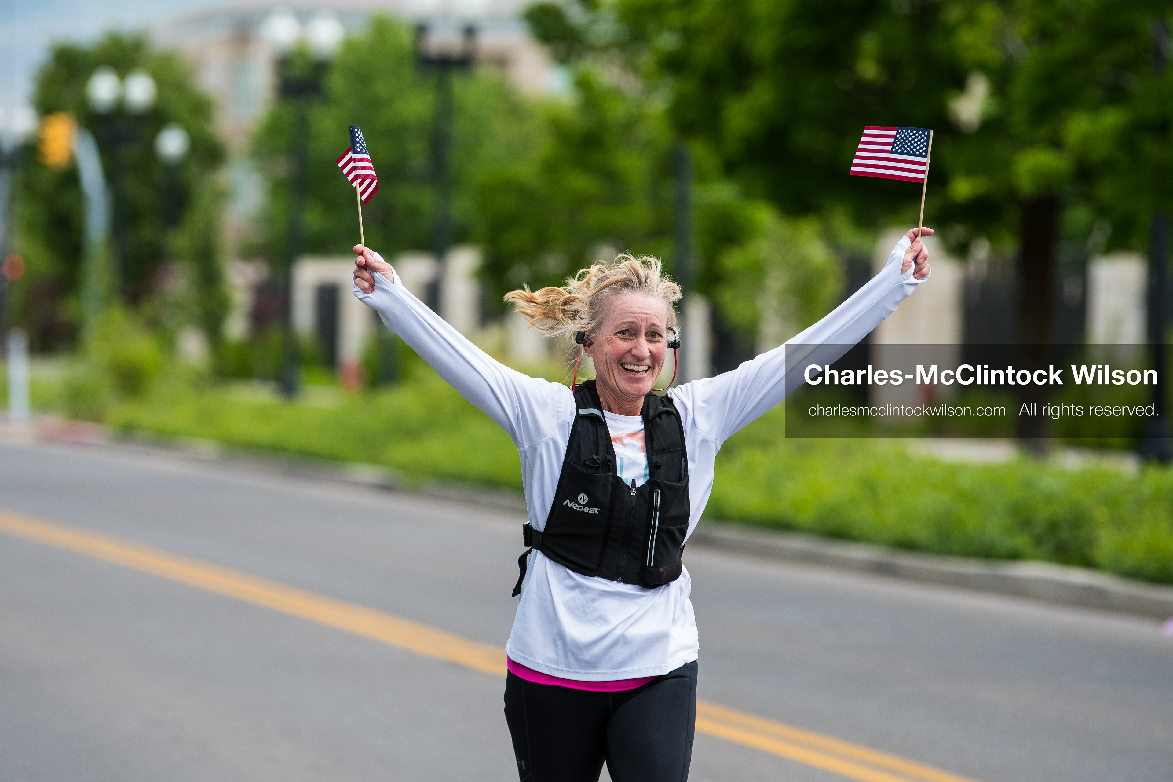 May 16, 2026, Ogden, Utah, USA: A runner waves two small American flags while participating in the 25th Annual America First Ogden Marathon in Ogden, Utah, on Saturday, May 16, 2026. The event marked the 25th running of the marathon, drawing thousands of participants and spectators. (Credit Image: © Charles-McClintock Wilson/ZUMA Press Wire)