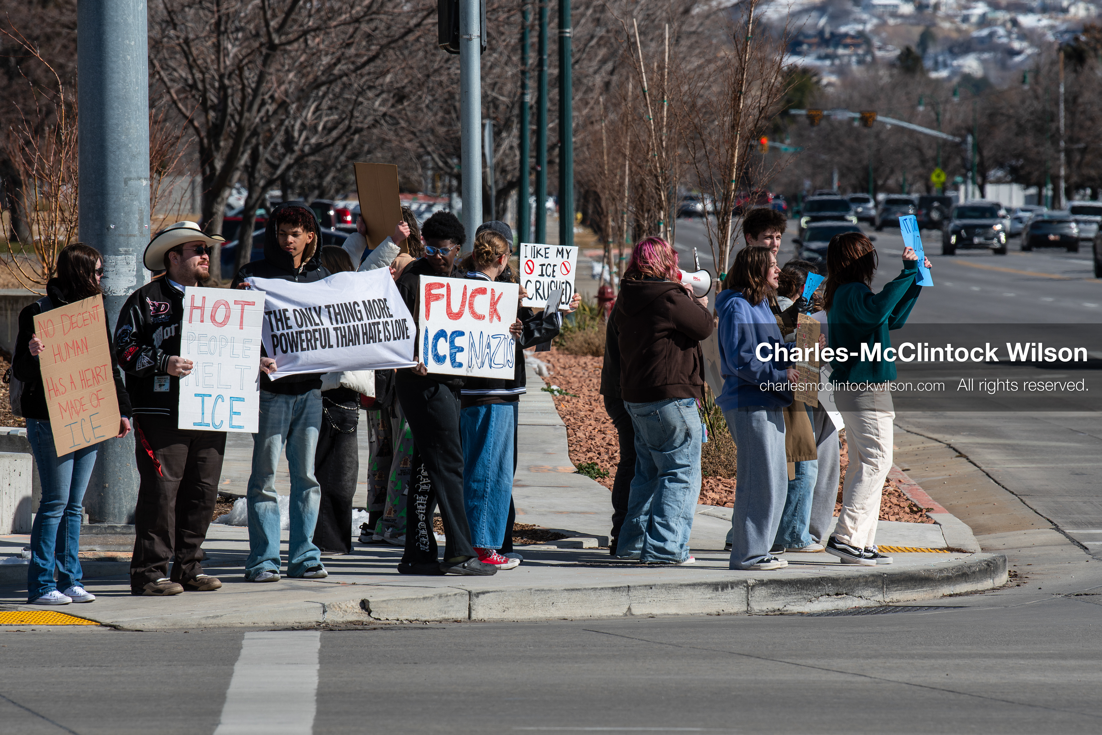 February 20, 2026, Orem, Utah, USA: High school students gather along State Street in front of Orem City Hall during a student led protest against ICE and federal immigration enforcement. Demonstrators hold signs as they stand near the roadway while traffic continues through the area. (Credit Image: © Charles McClintock Wilson/ZUMA Press Wire)