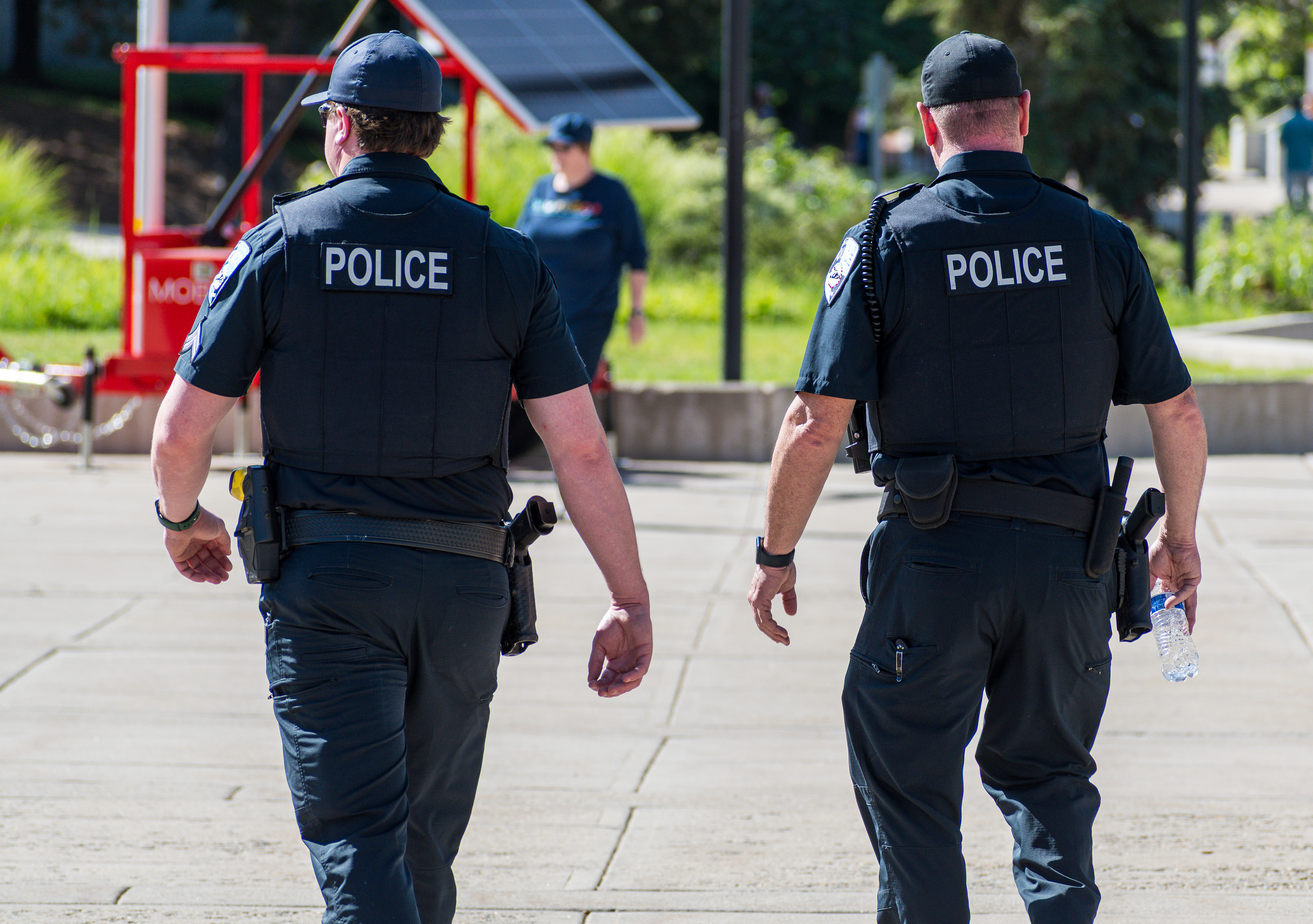 SALT LAKE CITY, UTAH – JUNE 14, 2025: Two police officers patrol the University of Utah campus during the “No Kings” protest calling for democracy and opposing authoritarian rule.