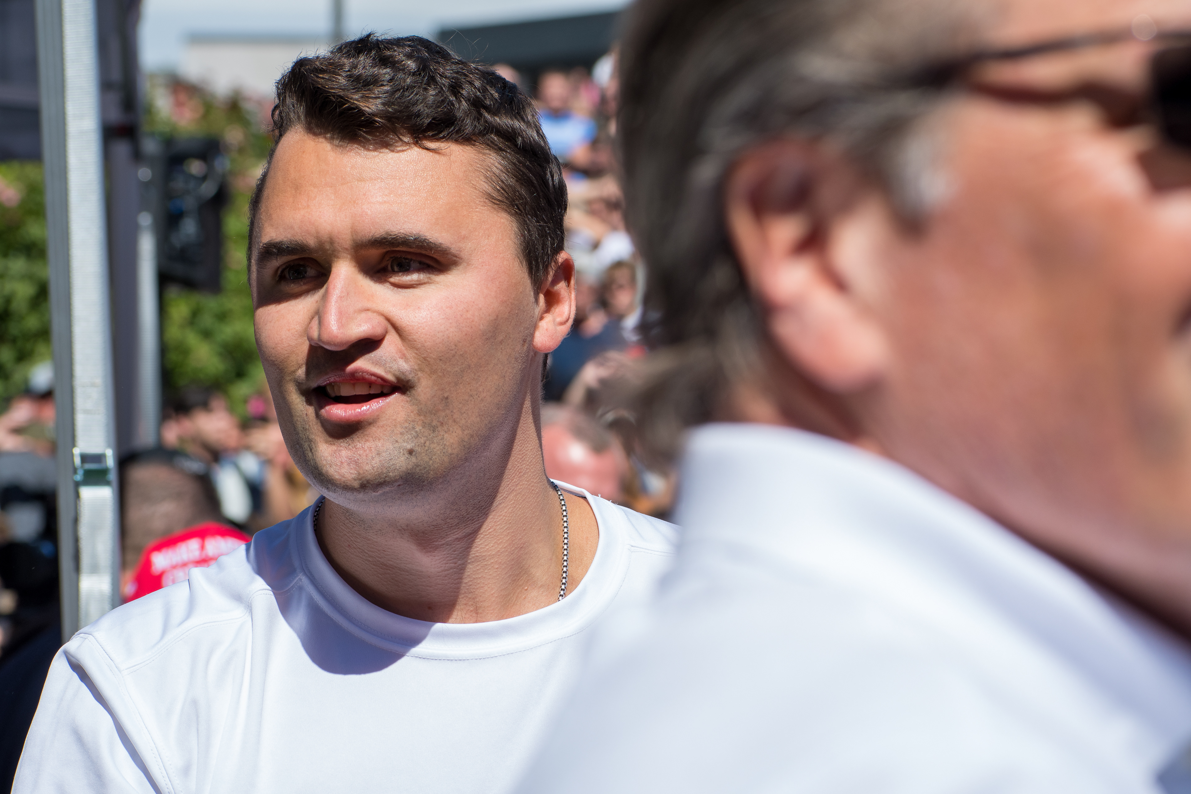 OREM, UTAH – SEPTEMBER 10, 2025: Charlie Kirk speaks with attendees during a public event at Utah Valley University. Positioned near a promotional booth and surrounded by supporters, Kirk appears engaged and expressive in one of his final public moments. The image reflects the atmosphere of direct outreach and energized dialogue that defined the gathering. © Charles-McClintock Wilson / ZUMA Press