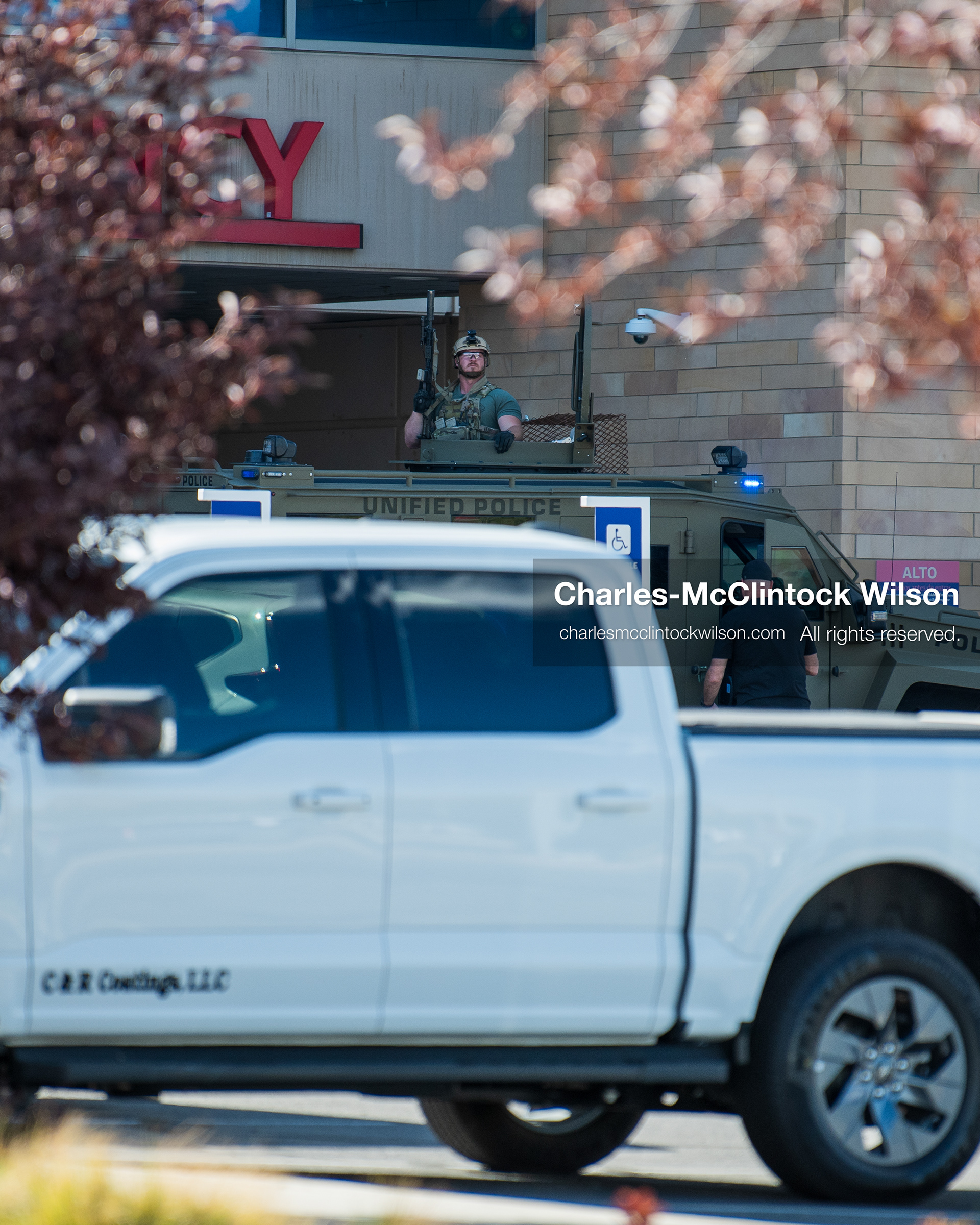 August 17, 2026, Murray, Utah, USA: A law enforcement officer stands inside the roof turret hatch of an armored tactical vehicle outside the emergency department entrance at Intermountain Medical Center in Murray, Utah, on Monday. Multiple police agencies secured the hospital perimeter as a safety precaution after shooting victims were brought in from a fatal shootout outside a funeral in nearby Kearns. (Credit Image: © Charles McClintock Wilson/ZUMA Press Wire)