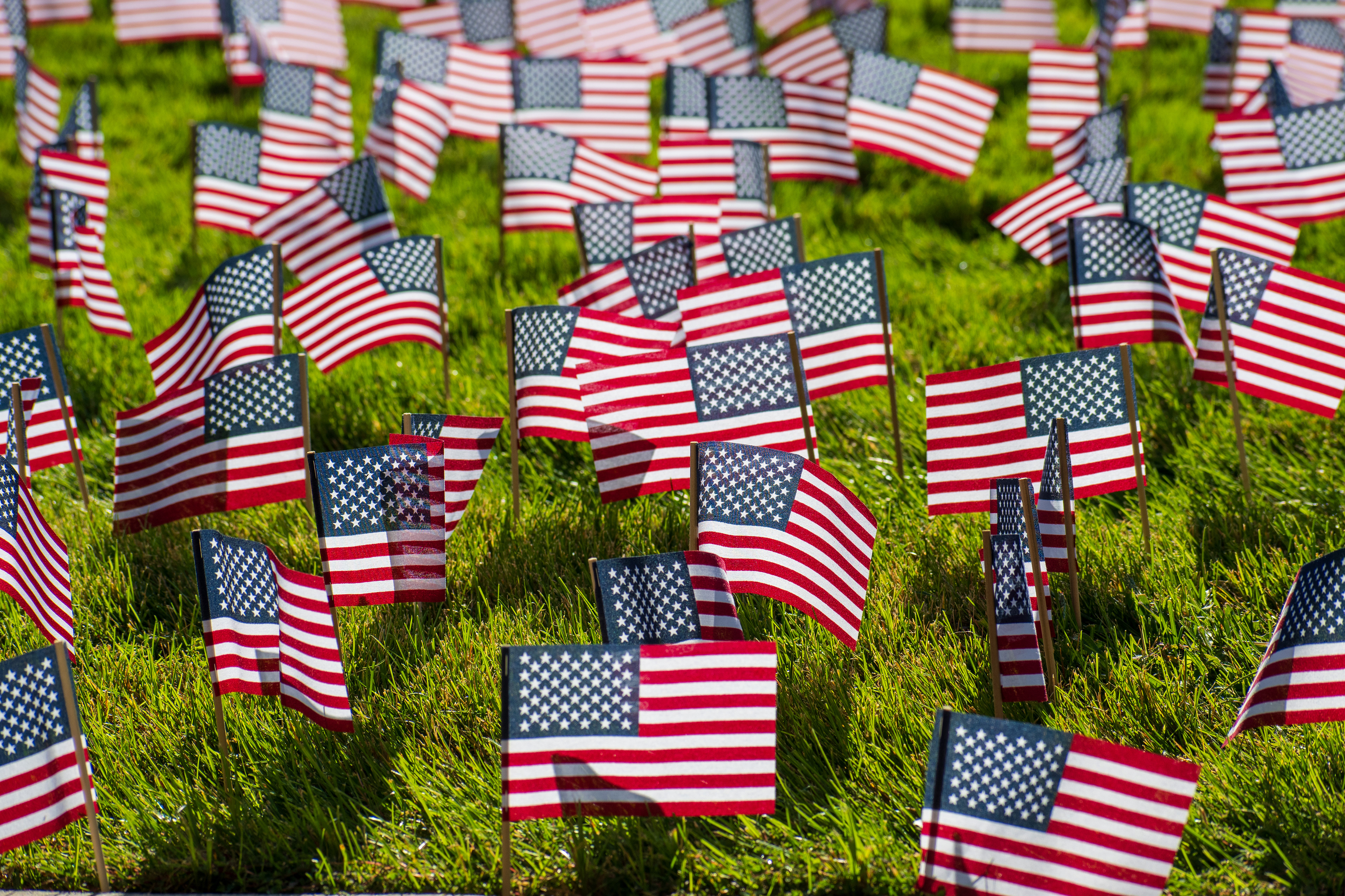 OREM, UTAH – SEPTEMBER 10, 2025: Hundreds of small American flags are planted in formation across the lawn at Utah Valley University during the opening stop of the American Comeback Tour. The installation reflects a moment of visual solemnity, symbolic presence, and commemorative clarity. The image captures the spatial rhythm and emotional resonance of a public gathering shaped by remembrance and civic engagement. © Charles-McClintock Wilson / ZUMA Press