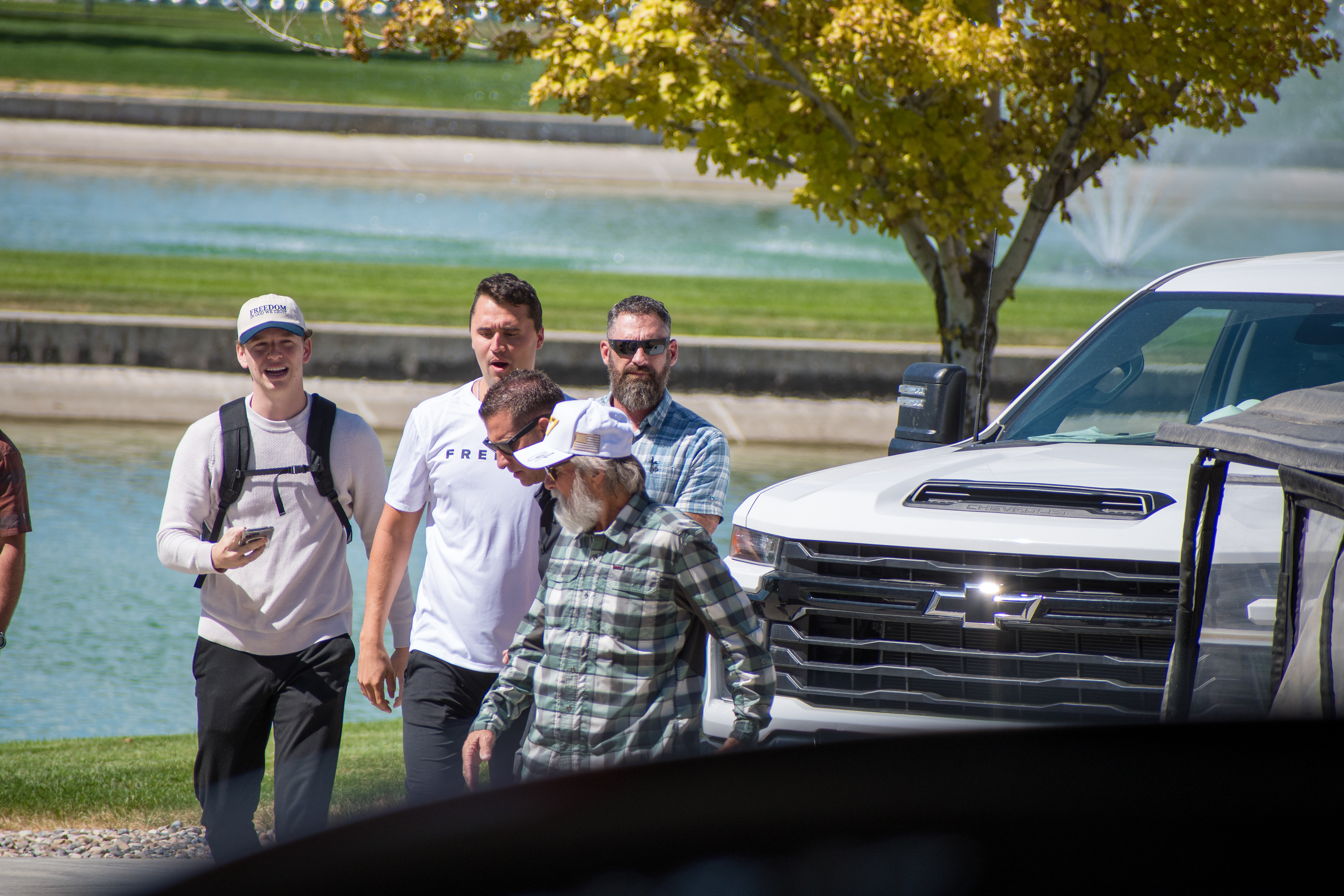 OREM, UTAH – SEPTEMBER 10, 2025: Charlie Kirk arrives at Utah Valley University for a scheduled public event. Walking near a water feature and surrounded by staff and supporters, Kirk enters the venue in a moment of calm anticipation. The image marks the beginning of his final public appearance, reflecting the quiet buildup before the crowd engagement that followed. © Charles-McClintock Wilson / ZUMA Press