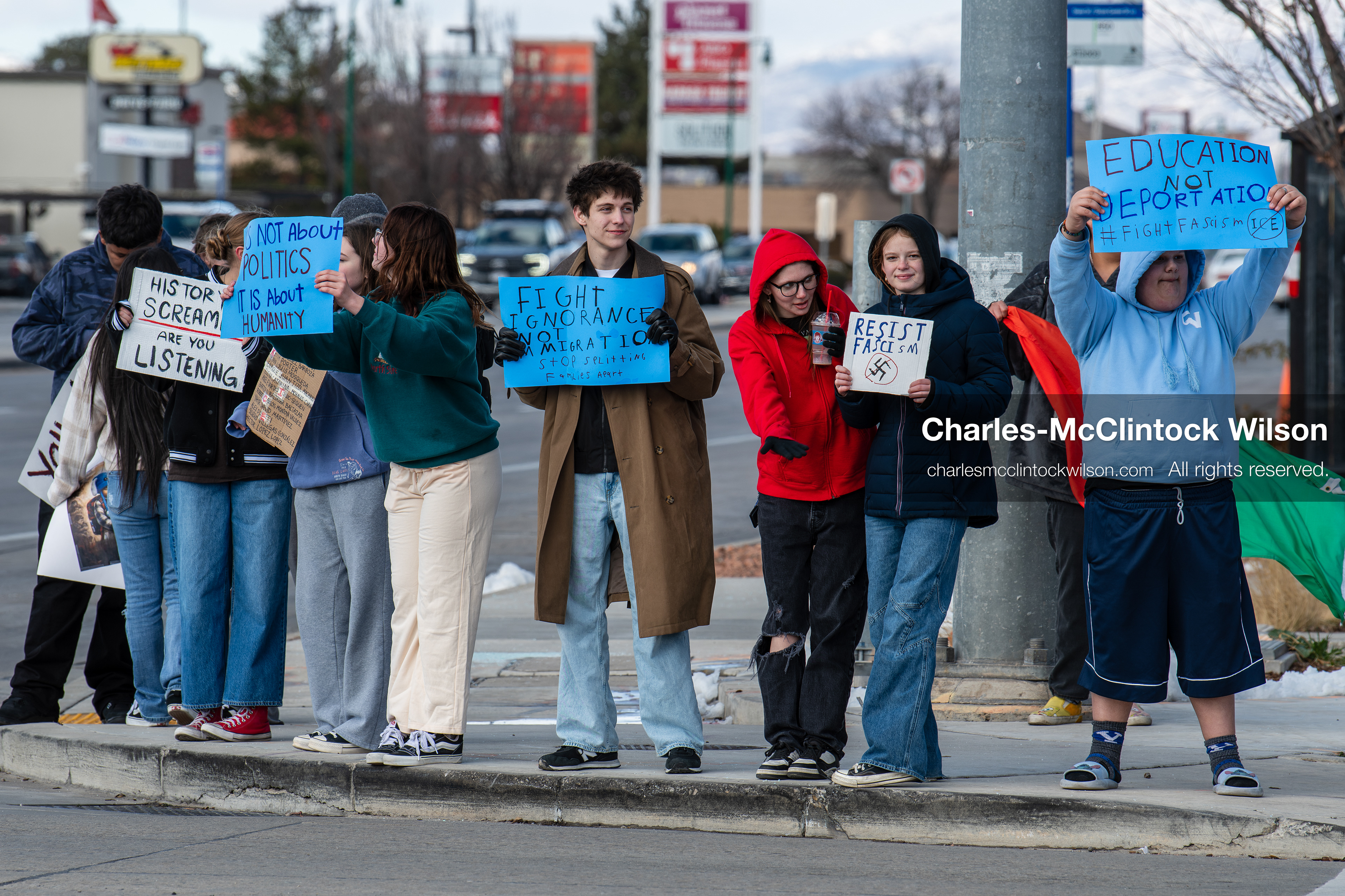 February 20, 2026, Orem, Utah, USA: High school students gather along State Street in front of Orem City Hall during a student led protest against ICE and federal immigration enforcement. Demonstrators hold signs as they stand near the roadway while traffic continues through the area. (Credit Image: © Charles McClintock Wilson/ZUMA Press Wire)