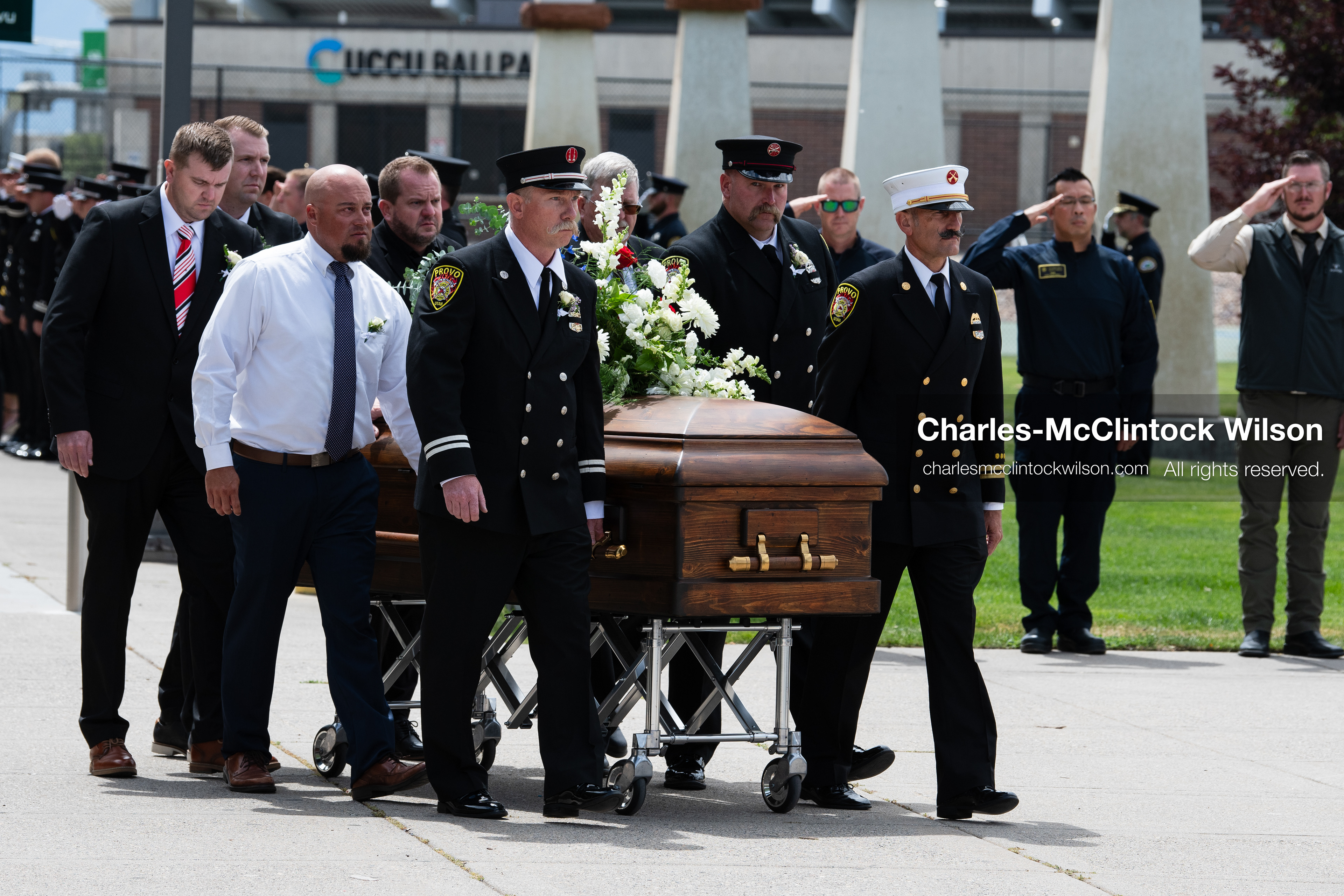 Firefighters and pallbearers escort the casket of Provo Fire Captain Spencer Long outside the UCCU Center on the campus of Utah Valley University in Orem, Utah, on Wednesday, July 29, 2026. More than 300 people came to the public memorial ceremony to honor Captain Long, his wife Katrina, and three of their sons, who died after a flash flood hit their campsite near the Sunglow Campground in Wayne County. (Photo by Charles-McClintock Wilson/Sipa USA)