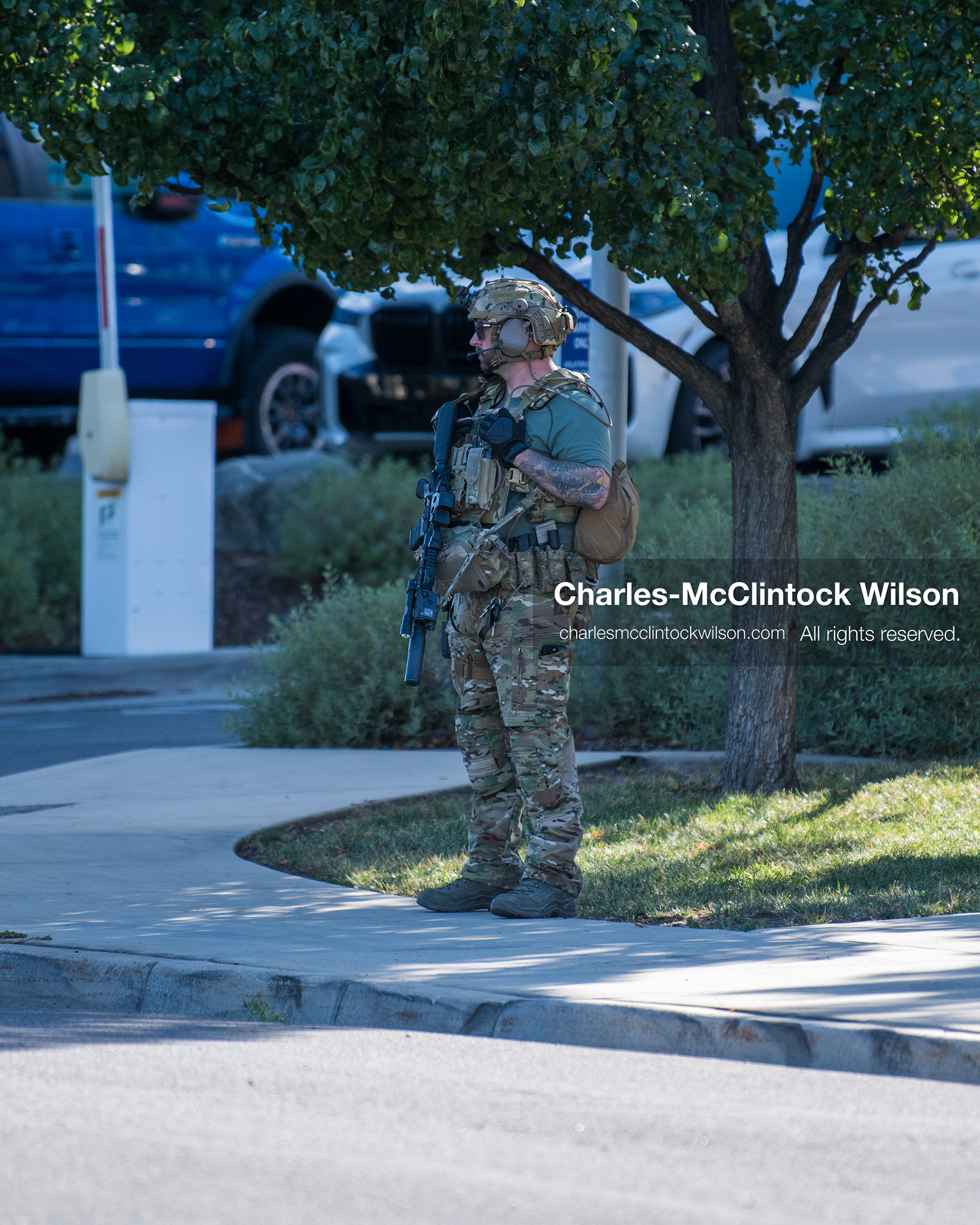 An armed law enforcement officer wearing a helmet and tactical gear stands guard outside Intermountain Medical Center in Murray, Utah, on Monday, August 17, 2026. Multiple regional law enforcement agencies converged to heavily secure the hospital perimeter as a safety precaution after shooting victims arrived from a fatal shootout that erupted outside a funeral service in nearby Kearns earlier that day. (Photo by Charles-McClintock Wilson/Sipa USA)