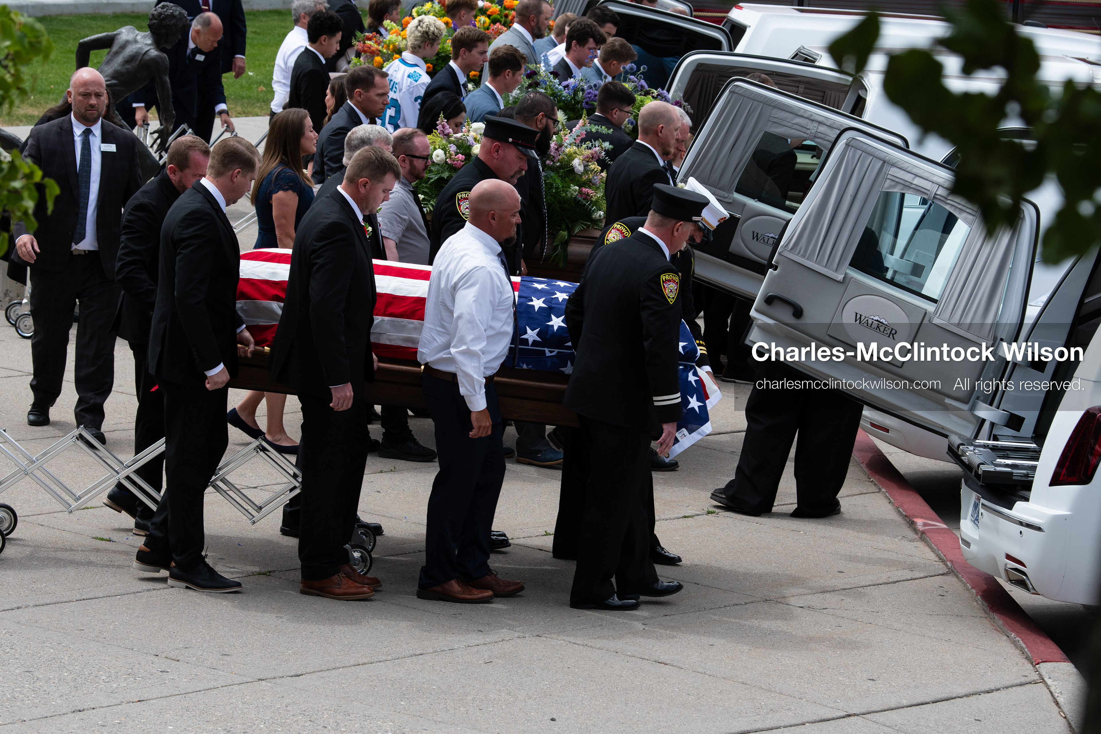 Firefighters and pallbearers load the flag-draped casket of Provo Fire Captain Spencer Long into a white hearse outside the UCCU Center at Utah Valley University in Orem, Utah, on Wednesday, July 29, 2026. More than 300 people came to the public memorial ceremony to honor Captain Long, his wife Katrina, and three of their sons, who died after a flash flood hit their campsite near the Sunglow Campground in Wayne County. (Photo by Charles-McClintock Wilson/Sipa USA)