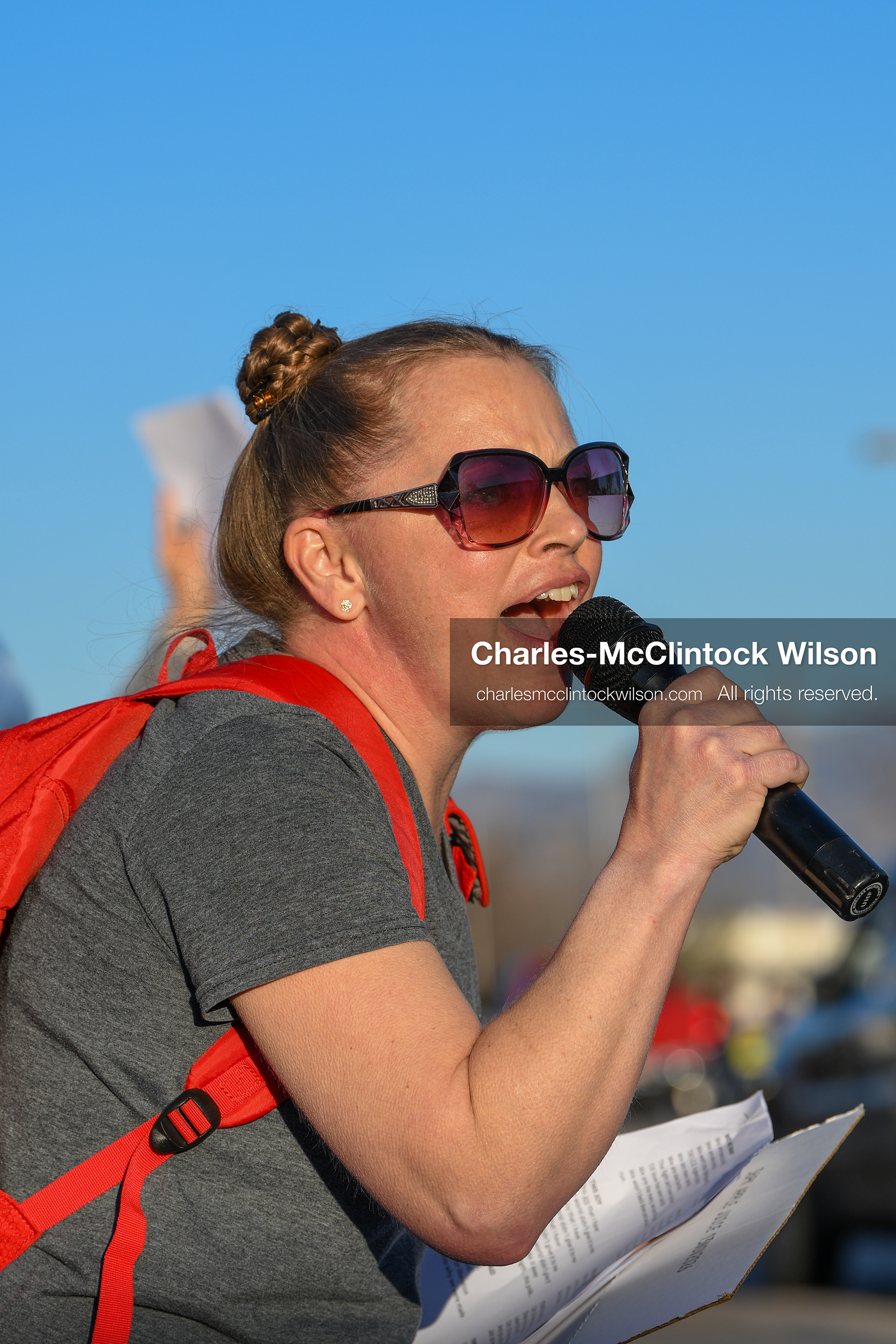 March 18, 2026, Salt Lake City, Utah, USA: A protester speaks into a microphone during a demonstration at the site of a proposed ICE detention facility on the west side of Salt Lake City. People gathered near the warehouse property as part of a community response to the planned use of the location. (Credit Image: © Charles McClintock Wilson/ZUMA Press Wire)