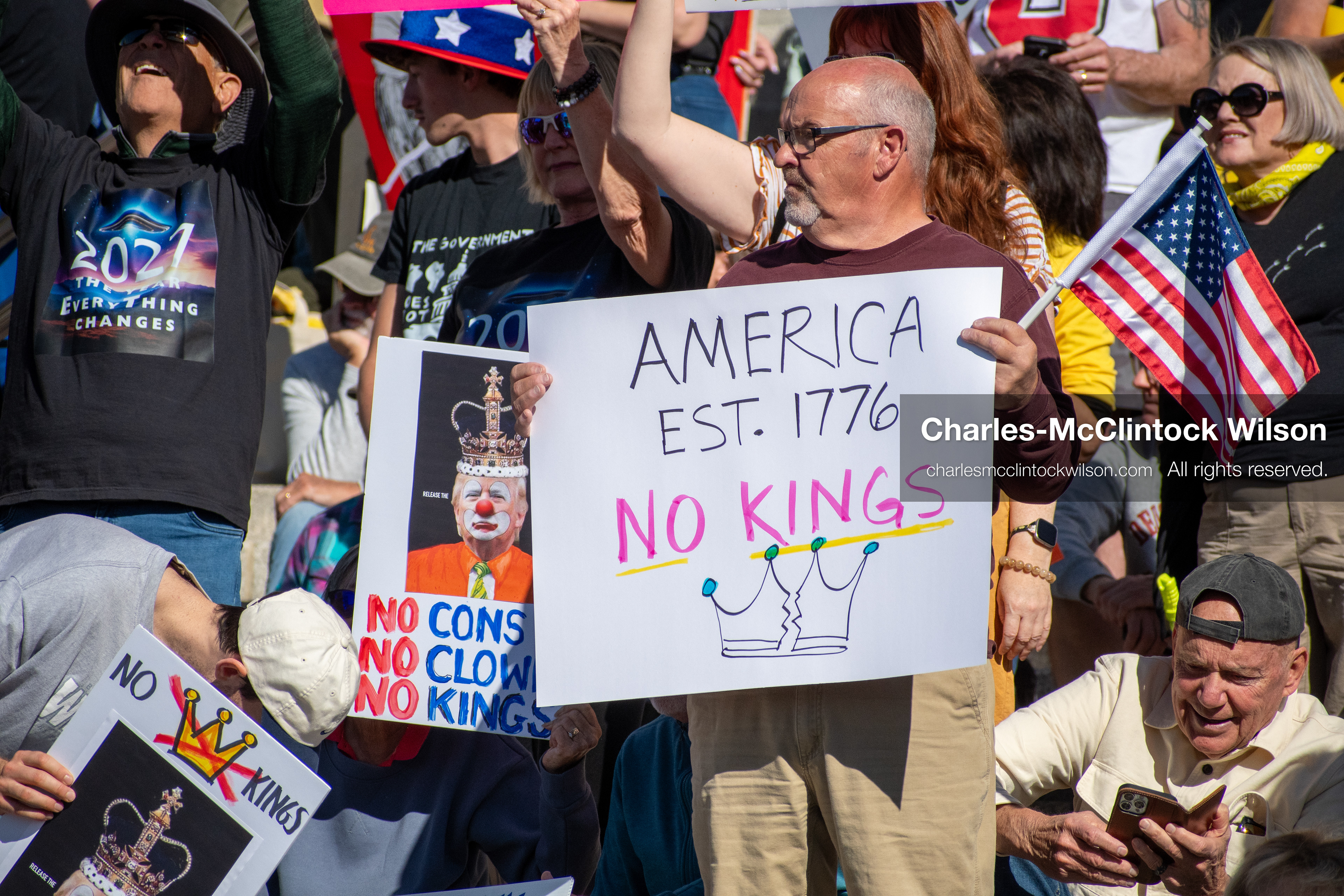 October 18, 2025, Salt Lake City, Utah, USA: Demonstrators gather on the steps of the Utah State Capitol during a "No Kings" protest held as part of a nationwide mobilization. Participants hold signs and flags while documenting the event. The protest was one of several organized across the United States.