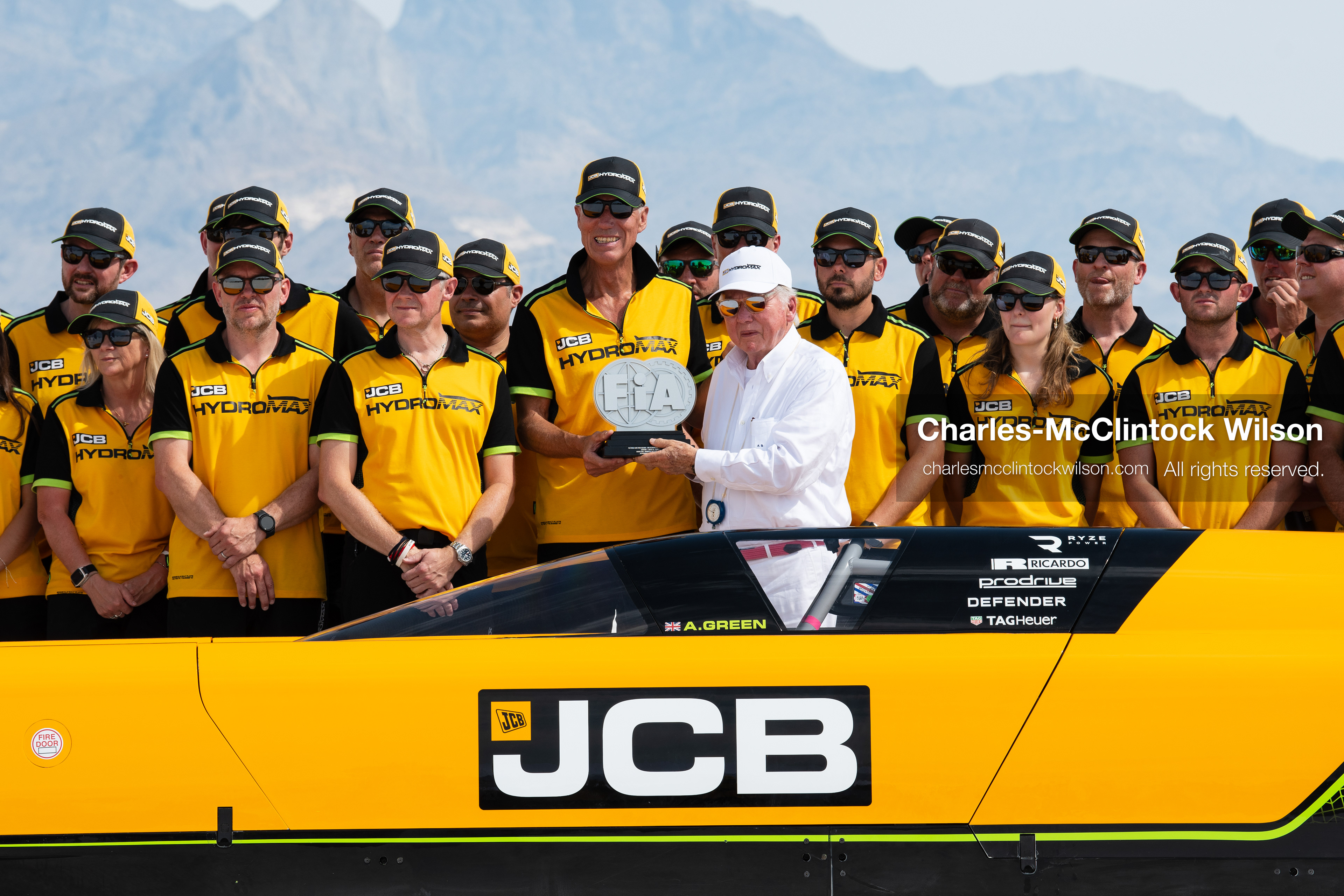 British driver Andy Green receives an official FIA land-speed record trophy from JCB Chairman Anthony Bamford on the Bonneville Salt Flats near Wendover, Utah, on August 11, 2026, after completing high-speed test runs in the hydrogen-powered JCB Hydromax streamliner. (Photo by Charles-McClintock Wilson/NurPhoto)