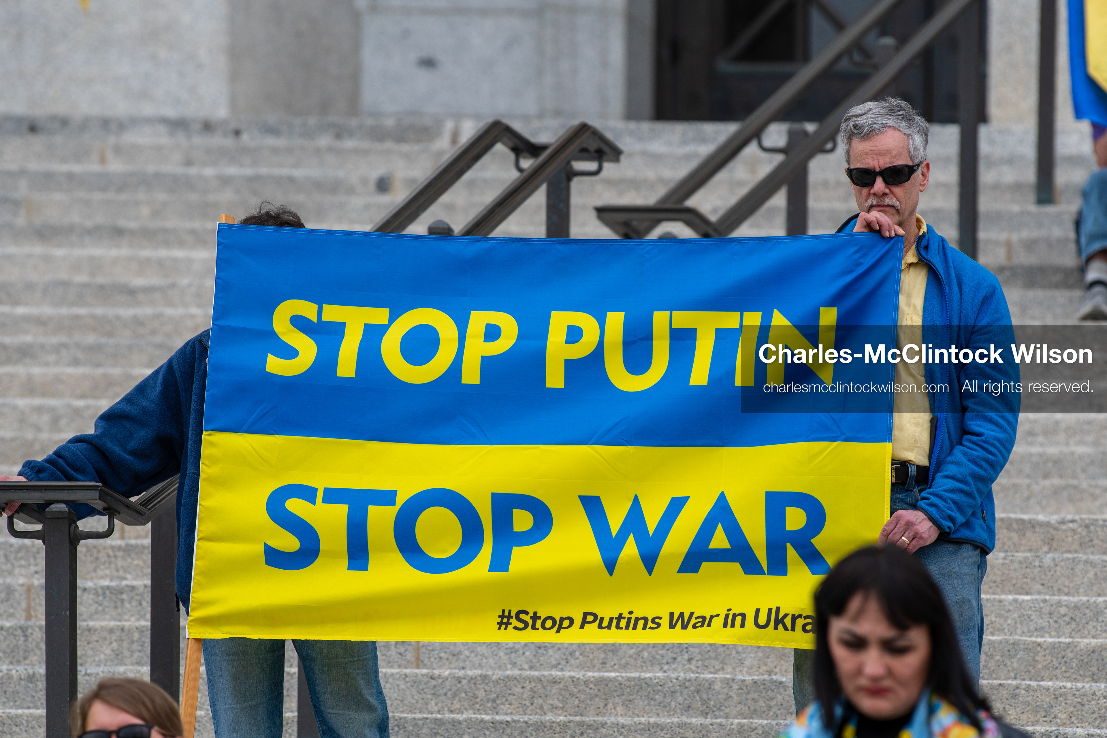  February 28, 2026, Salt Lake City, Utah, USA: Demonstrators hold a large blue and yellow banner resembling the Ukrainian flag with the words Stop Putin Stop War during the Stand With Ukraine rally at the Utah State Capitol. The gathering marked the four year anniversary of the full scale Russian invasion of Ukraine and brought community members together in support of Ukrainians and local humanitarian efforts. (Credit Image: © Charles McClintock Wilson/ZUMA Press Wire)