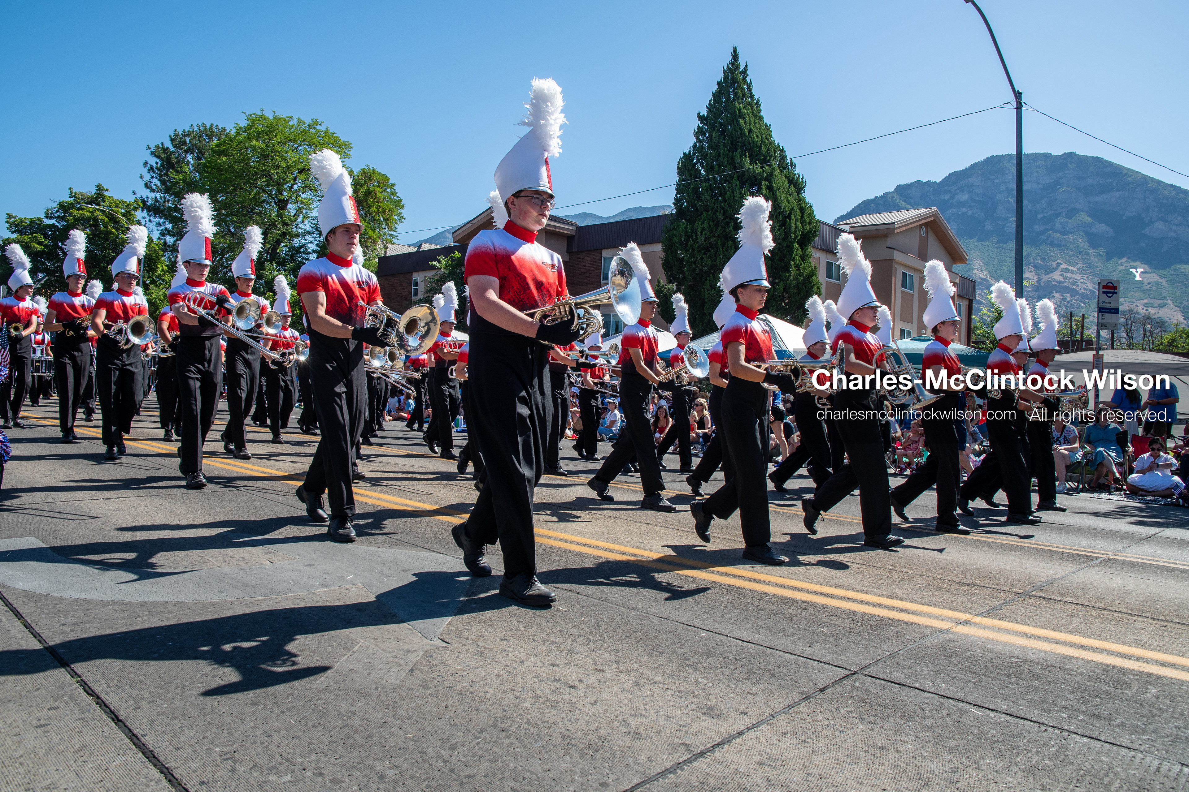 July 4, 2026, Provo, Utah, USA: Members of a high school marching band dressed in maroon and black uniforms play brass instruments while marching down the street during America's Freedom Festival Grand Parade in Provo, Utah, Saturday, July 4, 2026. The annual Independence Day event features expanded programming to honor the 250th anniversary of United States independence. (Credit Image: © Charles-McClintock Wilson/ZUMA Press Wire)