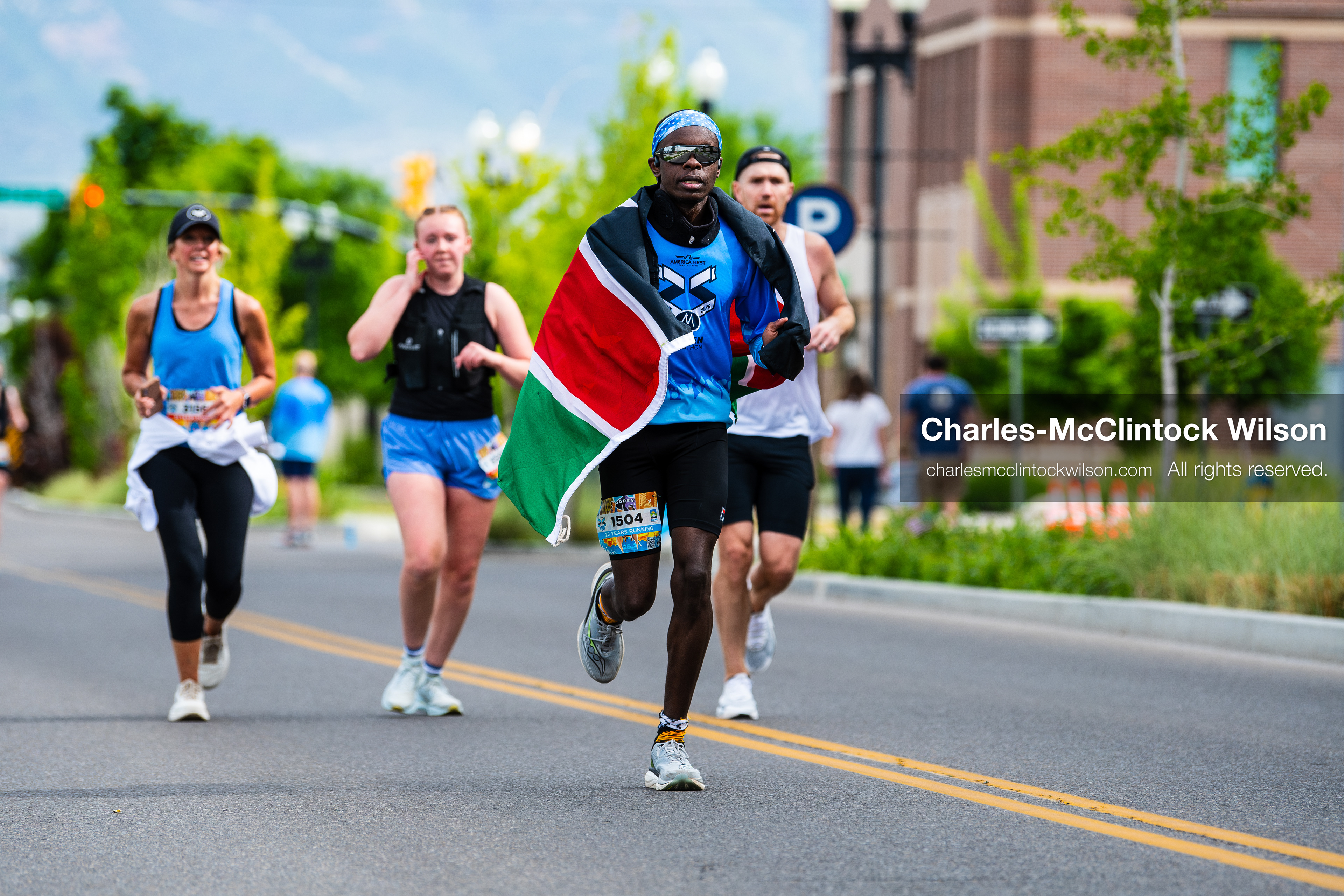 May 16, 2026, Ogden, Utah, USA: A runner draped in the Kenyan flag competes in the 25th Annual America First Ogden Marathon in Ogden, Utah, on Saturday, May 16, 2026. The event drew thousands of participants and spectators for the milestone 25th running of the marathon. (Credit Image: © Charles-McClintock Wilson/ZUMA Press Wire)