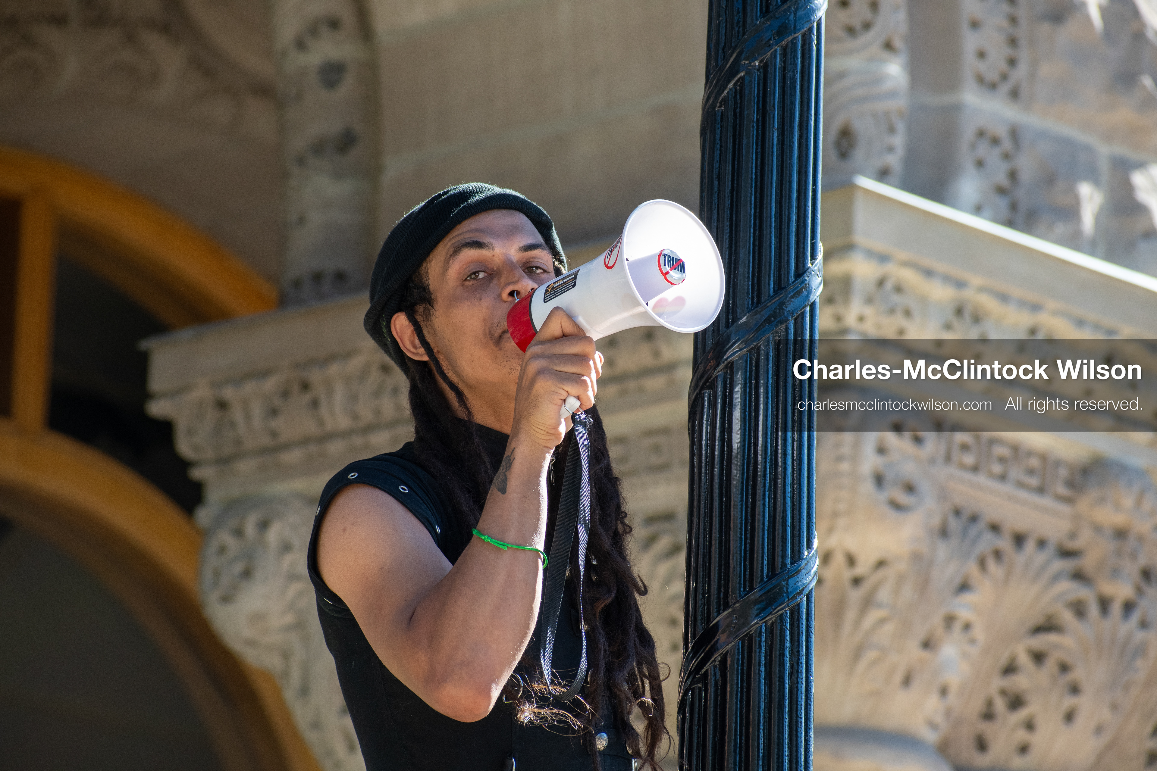 October 18, 2025, Salt Lake City, Utah, USA: A demonstrator speaks through a megaphone during a "No Kings" rally at Washington Square Park in Salt Lake City, Utah. The protest was part of a nationwide mobilization.