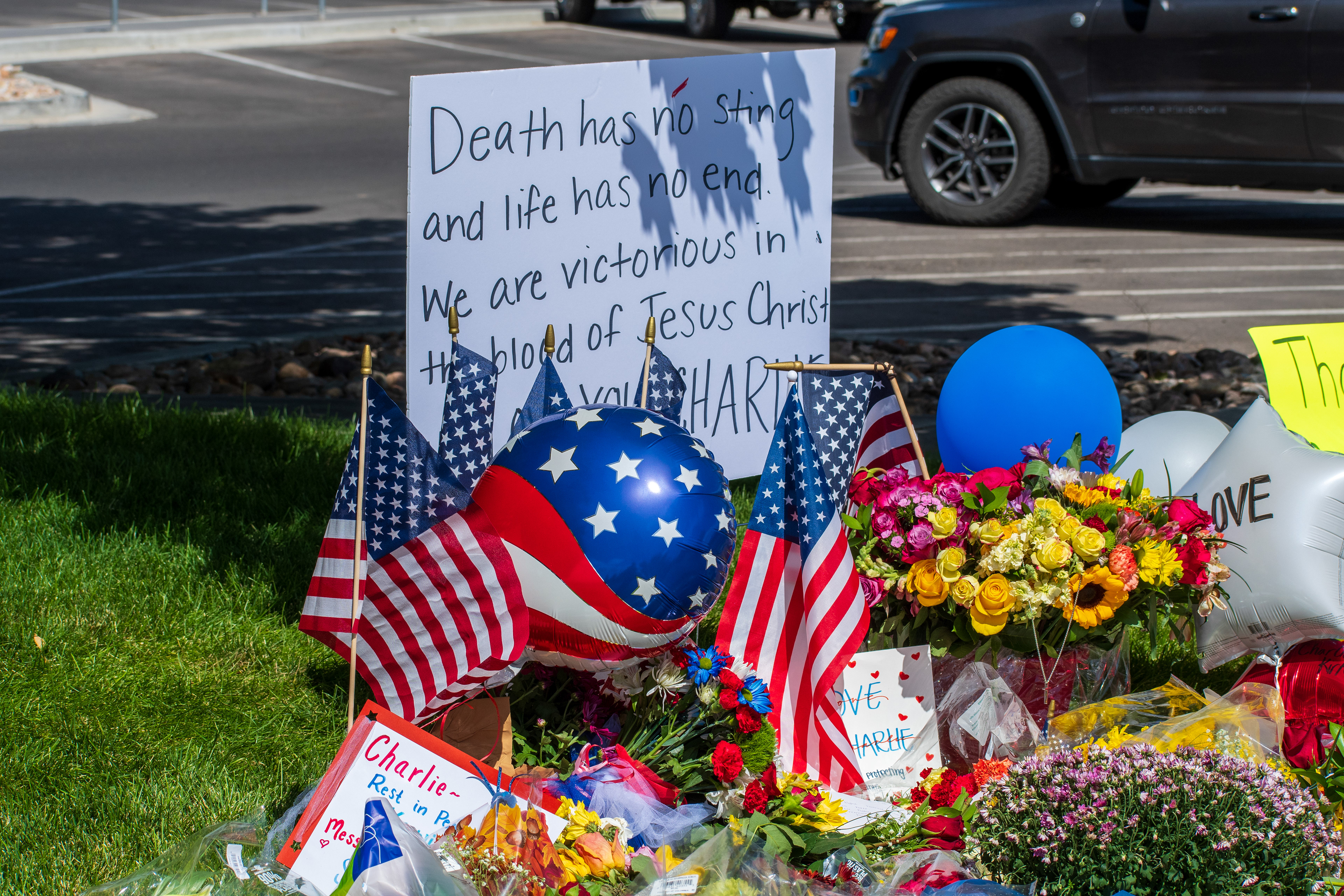OREM, UTAH – SEPTEMBER 12, 2025: Flowers, American flags, balloons, and handwritten posters are arranged on a grassy memorial site for Charlie Kirk near Utah Valley University. The tribute reflects a collective expression of remembrance and community solidarity. © Charles‑McClintock Wilson / ZUMA Press