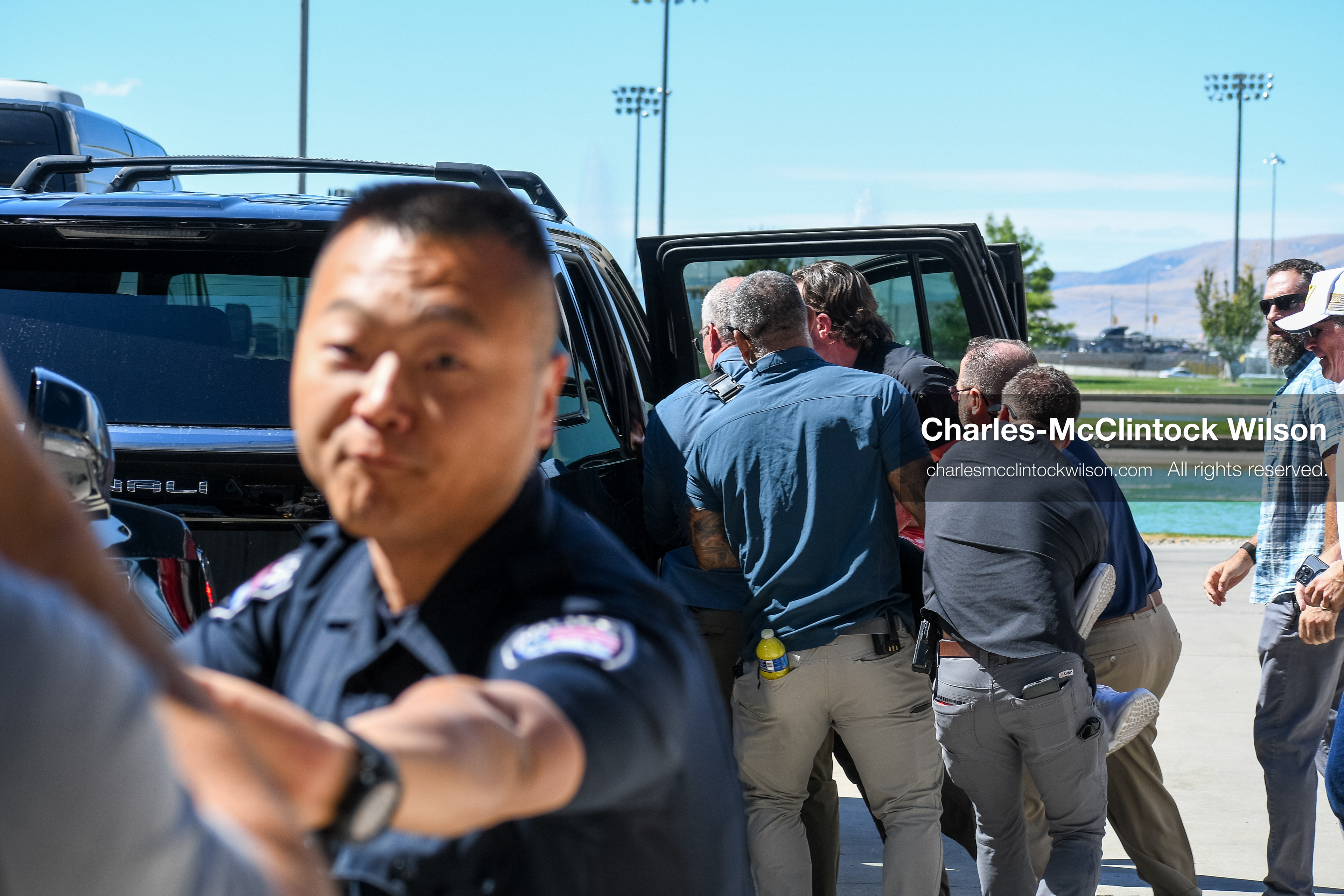 September 10, 2025, Orem, Utah, USA: Law enforcement and security personnel coordinate the evacuation of conservative activist Charlie Kirk following a shooting during a public event at Utah Valley University. Kirk is transported to the hospital as emergency protocols unfold. He died from his injuries a few hours later. Officers secure the vehicle and manage crowd control amid a multi-agency response. (Credit Image: © Charles-McClintock Wilson/ZUMA Press Wire)