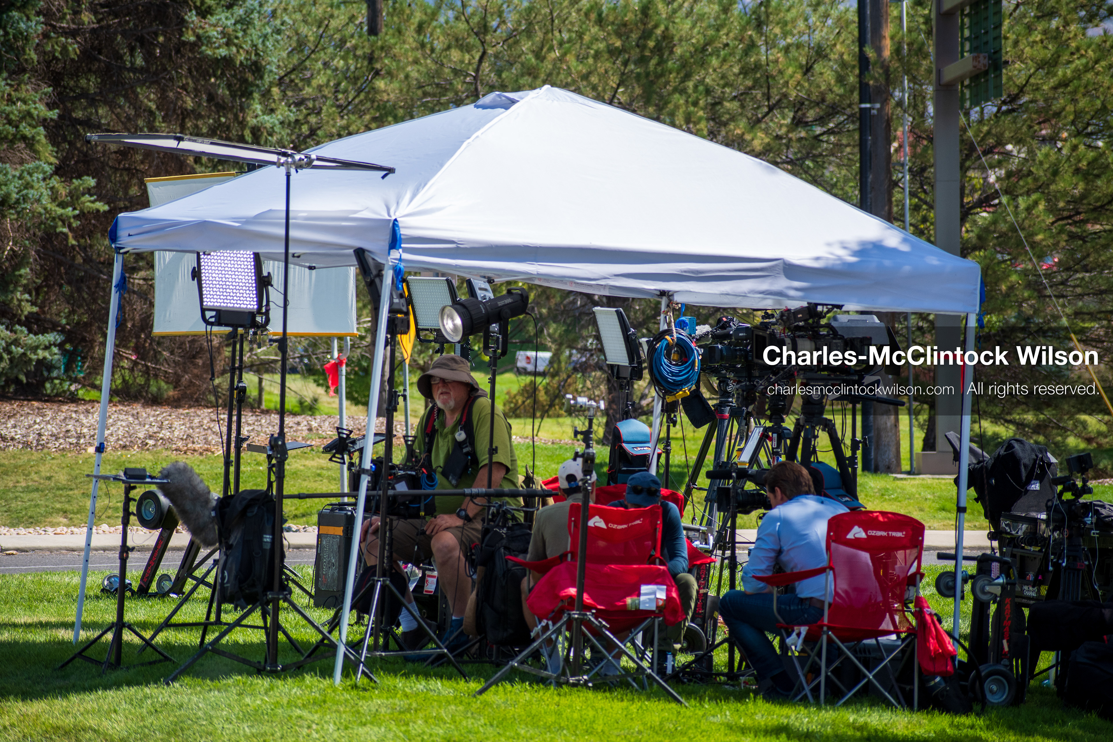 September 12, 2025, Orem, Utah, USA: Members of the press operate cameras and audio equipment beneath a canopy near the site of the fatal shooting of conservative activist Charlie Kirk at Utah Valley University. The media setup includes tripods, boom microphones, and LED lights as crews prepare for live coverage following the September 10 incident.   (Credit Image: © Charles‑McClintock Wilson/ZUMA Press Wire)