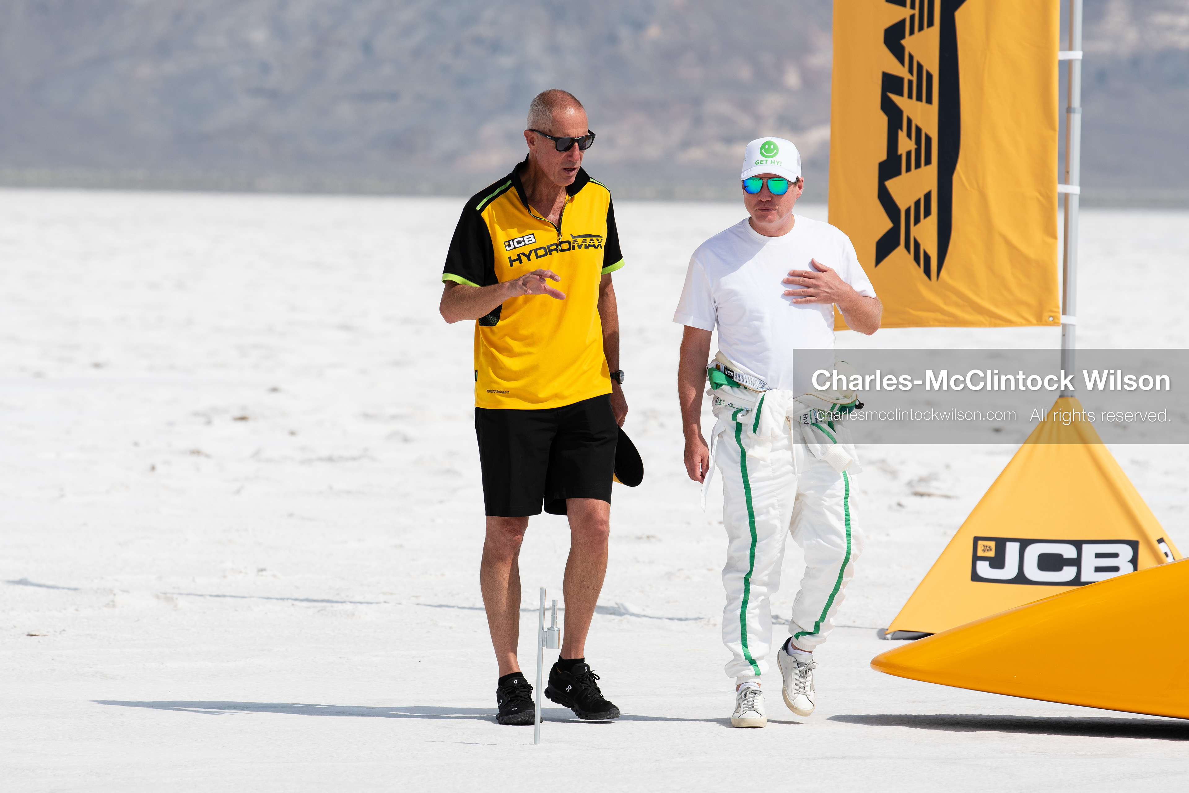 British pilot Andy Green walks and talks with a team technician on the Bonneville Salt Flats on Tuesday. Green navigated the hydrogen-powered "JCB Hydromax" streamliner to a historic record-breaking top speed of 406.320 mph during the official speed trials. (Photo by Charles-McClintock Wilson/Sipa USA)
