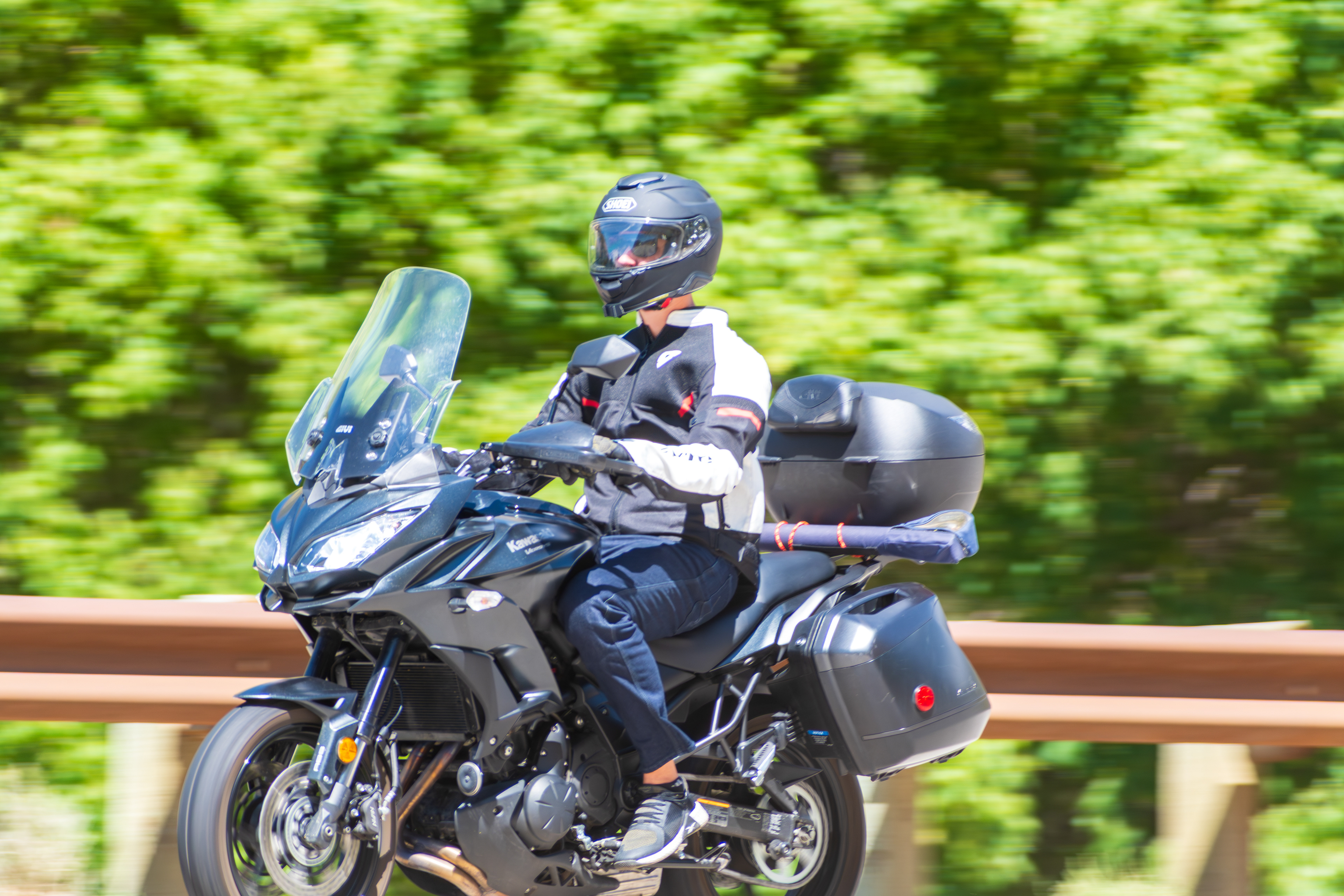 Provo Canyon, Utah, USA — September 1, 2025: A motorcyclist travels northbound along U.S. Route 189, framed by canyon foliage and roadside infrastructure.