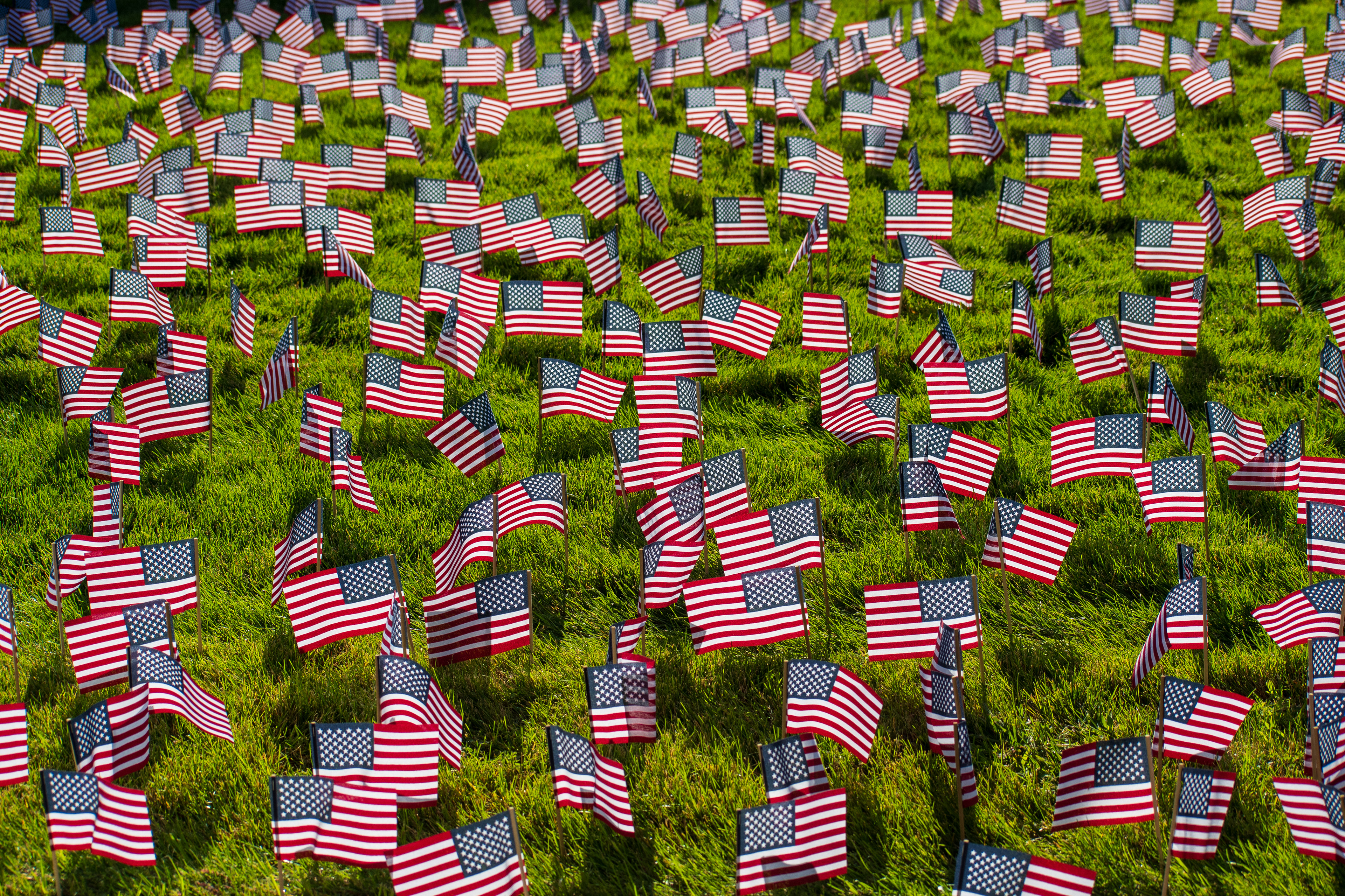 OREM, UTAH – SEPTEMBER 10, 2025: Hundreds of small American flags are planted in formation across the lawn at Utah Valley University during the opening stop of the American Comeback Tour. The installation reflects a moment of visual solemnity, symbolic presence, and commemorative clarity. The image captures the spatial rhythm and emotional resonance of a public gathering shaped by remembrance and civic engagement. © Charles-McClintock Wilson / ZUMA Press