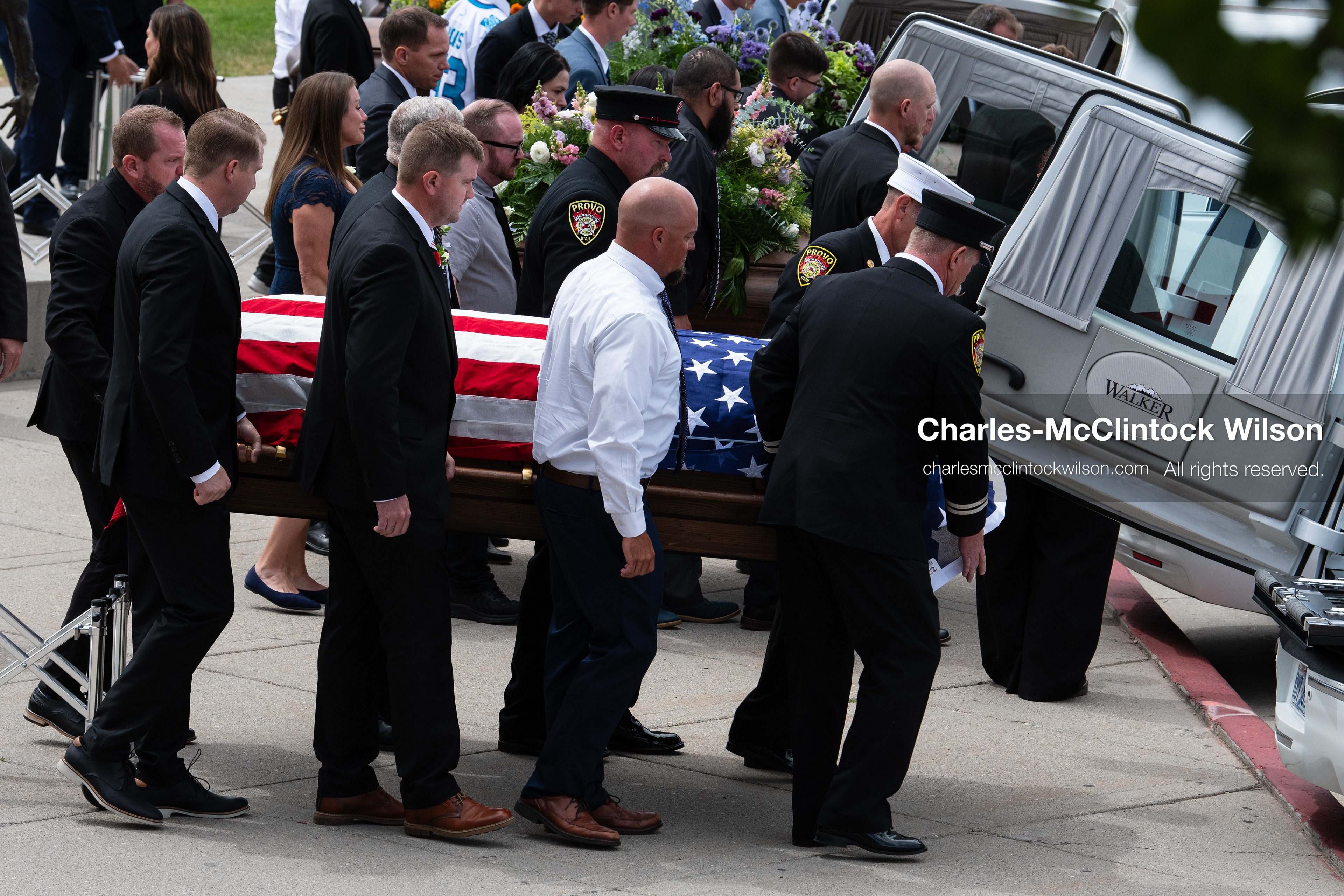 Firefighters and pallbearers load the flag-draped casket of Provo Fire Captain Spencer Long into a white hearse outside the UCCU Center at Utah Valley University in Orem, Utah, on Wednesday, July 29, 2026. More than 300 people came to the public memorial ceremony to honor Captain Long, his wife Katrina, and three of their sons, who died after a flash flood hit their campsite near the Sunglow Campground in Wayne County. (Photo by Charles-McClintock Wilson/Sipa USA)