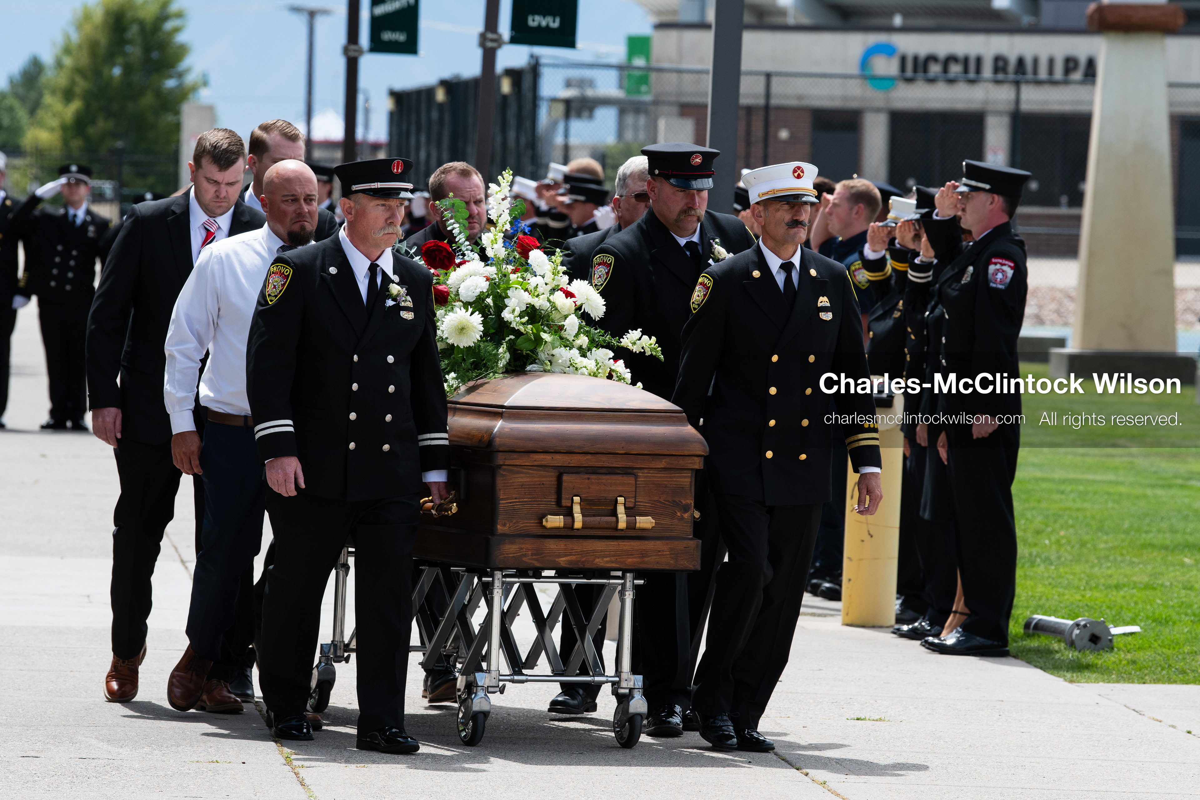 Firefighters and pallbearers escort the casket of Provo Fire Captain Spencer Long outside the UCCU Center on the campus of Utah Valley University in Orem, Utah, on Wednesday, July 29, 2026. More than 300 people came to the public memorial ceremony to honor Captain Long, his wife Katrina, and three of their sons, who died after a flash flood hit their campsite near the Sunglow Campground in Wayne County. (Photo by Charles-McClintock Wilson/Sipa USA)