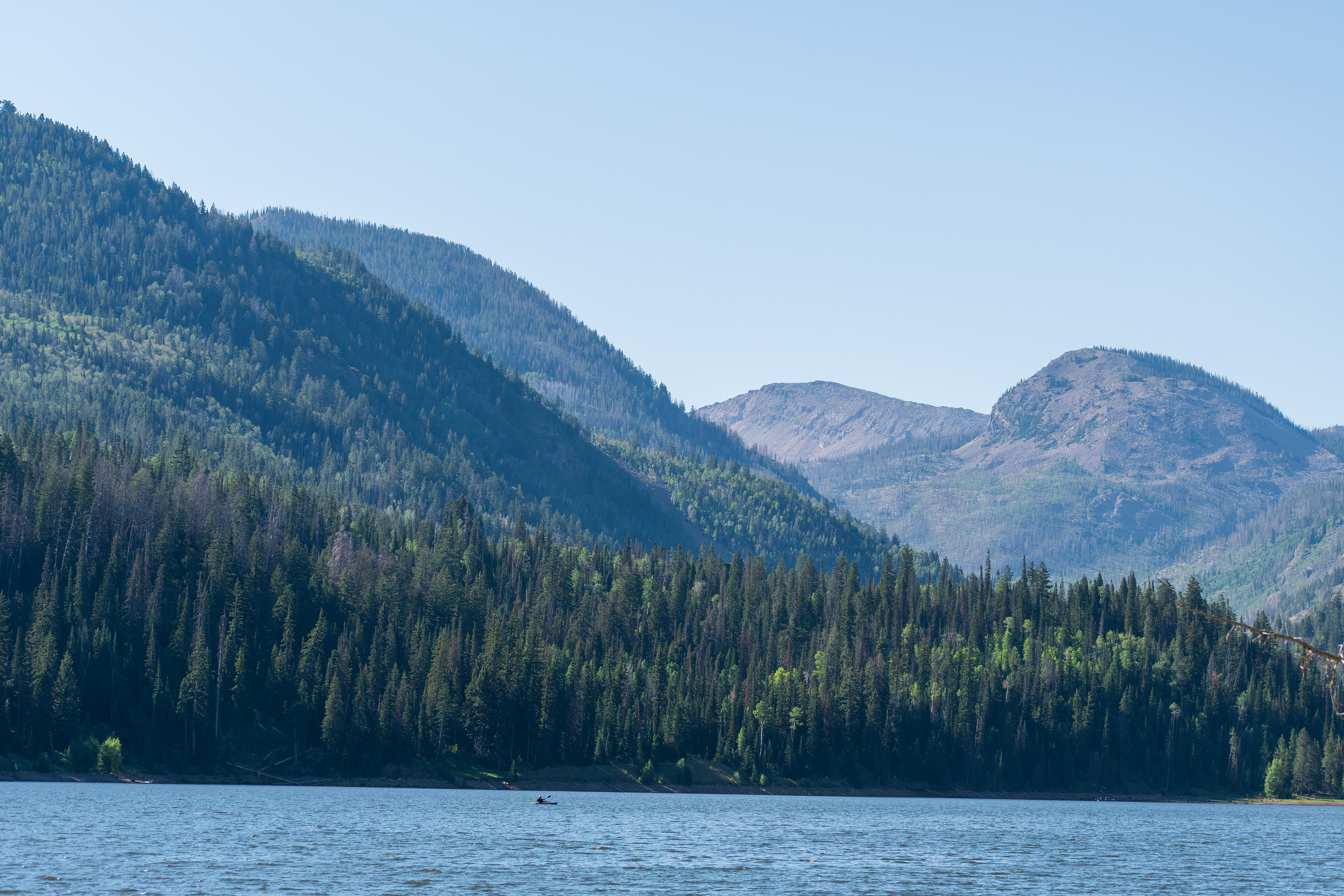 Summit County, Utah – July 20, 2025: A scenic view of Smith and Morehouse Reservoir with forested mountains rising in the background on a clear summer day.