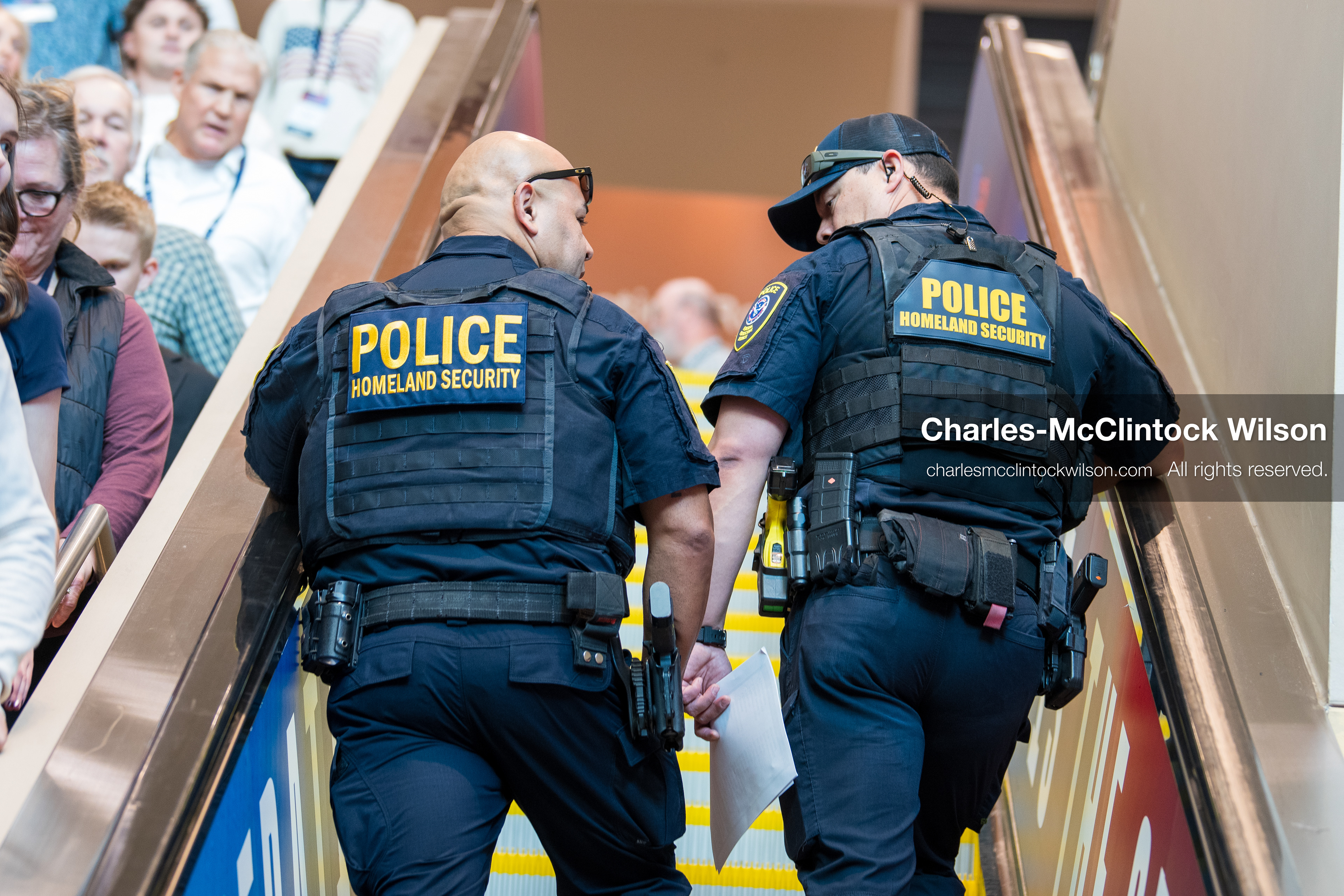 December 18, 2025, Phoenix, Arizona, USA: Two U.S. Department of Homeland Security officers ride an escalator during AmericaFest 2025 at the Phoenix Convention Center, the first edition of the event held since the death of Charlie Kirk. (Credit Image: (c) Charles-McClintock Wilson/ZUMA Press Wire)