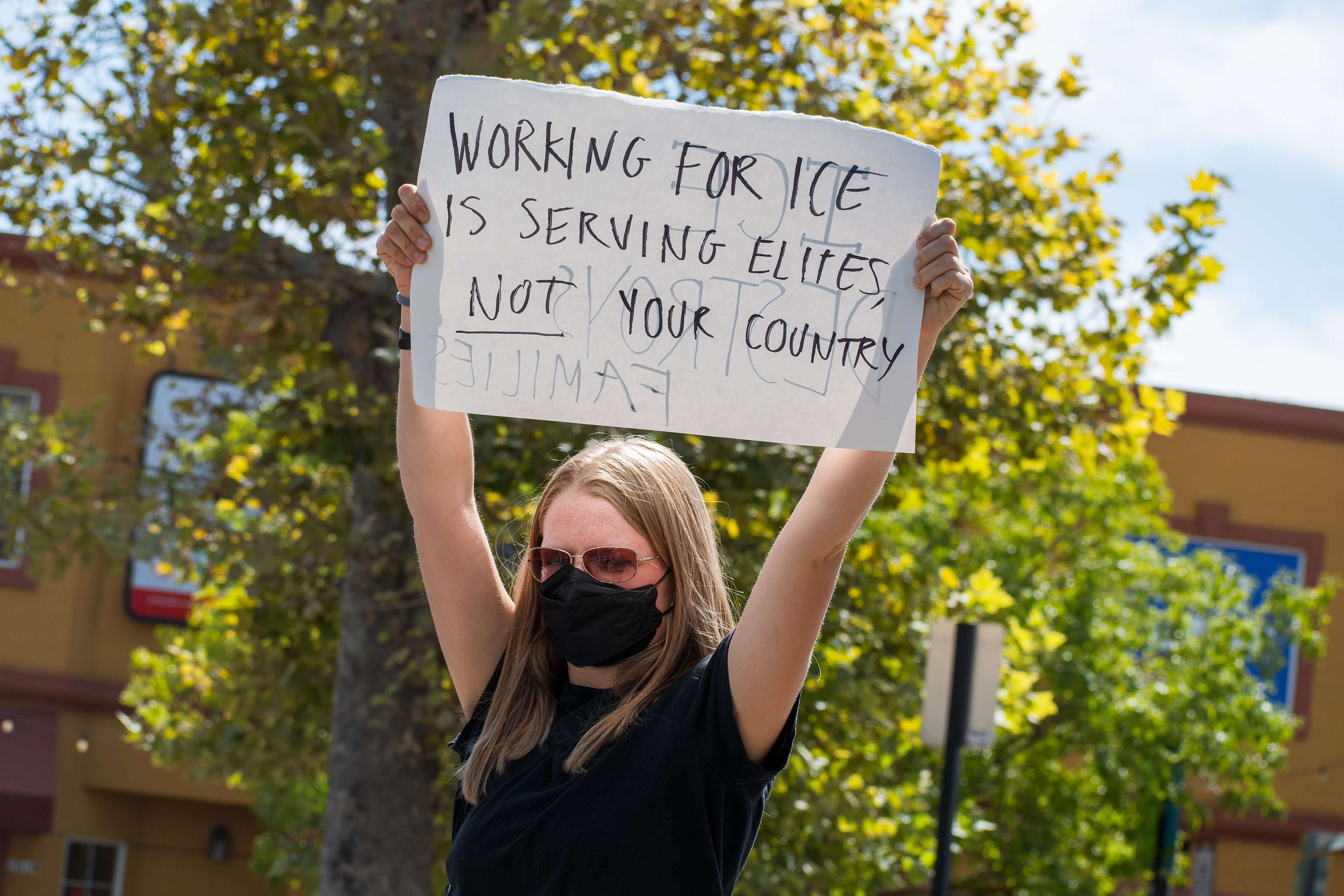 September 15, 2025 – Provo, Utah, United States: A demonstrator holds a sign reading “WORKING FOR ICE IS SERVING ELITES NOT YOUR COUNTRY” outside the Utah Valley Convention Center during a protest against the Department of Homeland Security career expo. The crossed-out word “FAMILIES” at the bottom of the sign adds layered critique of immigration enforcement’s impact on family unity. Photograph by Charles‑McClintock Wilson / ZUMA Press Wire