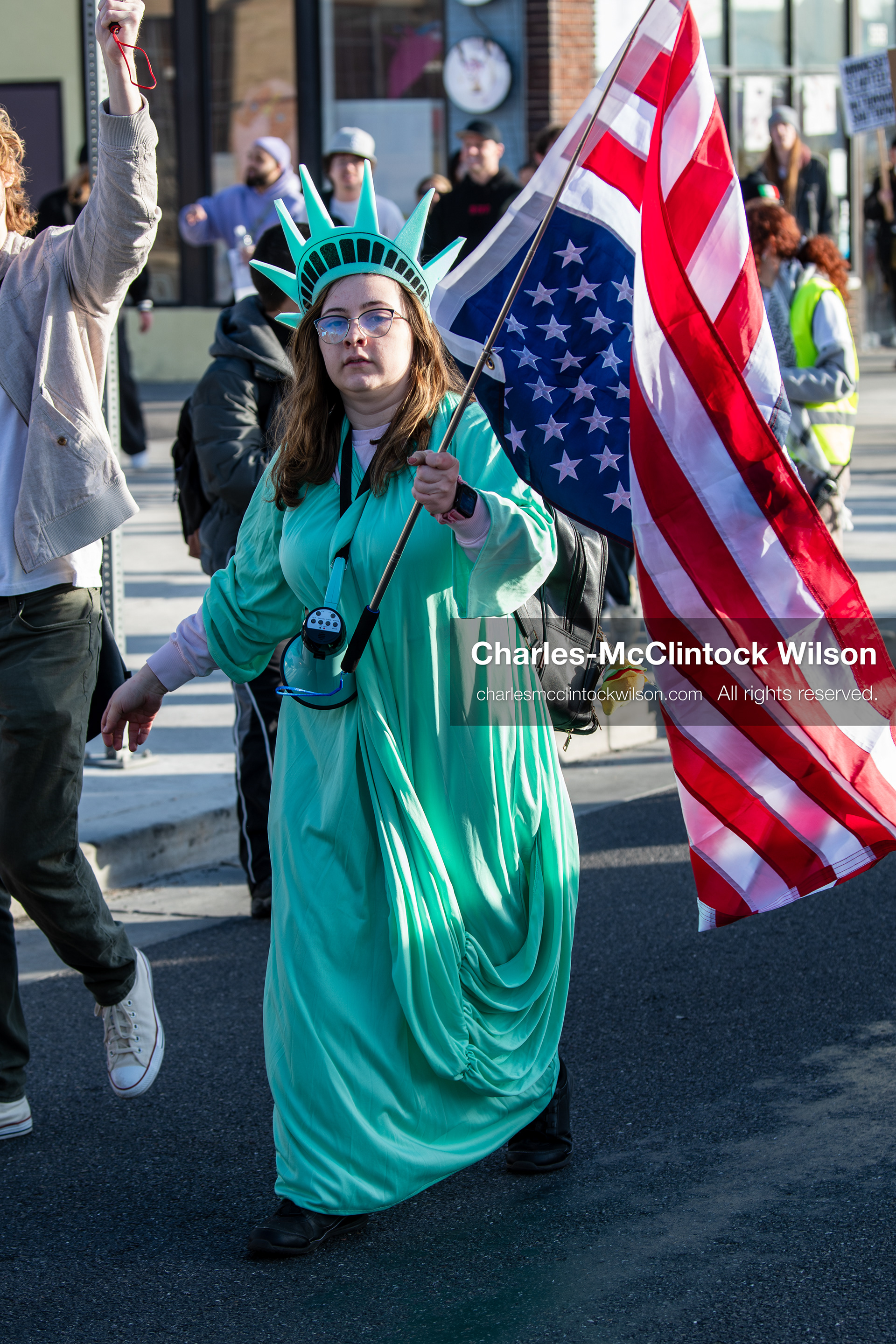 January 30, 2026, Salt Lake City, Utah, USA: A demonstrator dressed as the Statue of Liberty carries an American flag during an anti‑ICE protest in Salt Lake City, part of a nationwide response to immigration enforcement policies. (Credit Image: © Charles‑McClintock Wilson/ZUMA Press Wire)
