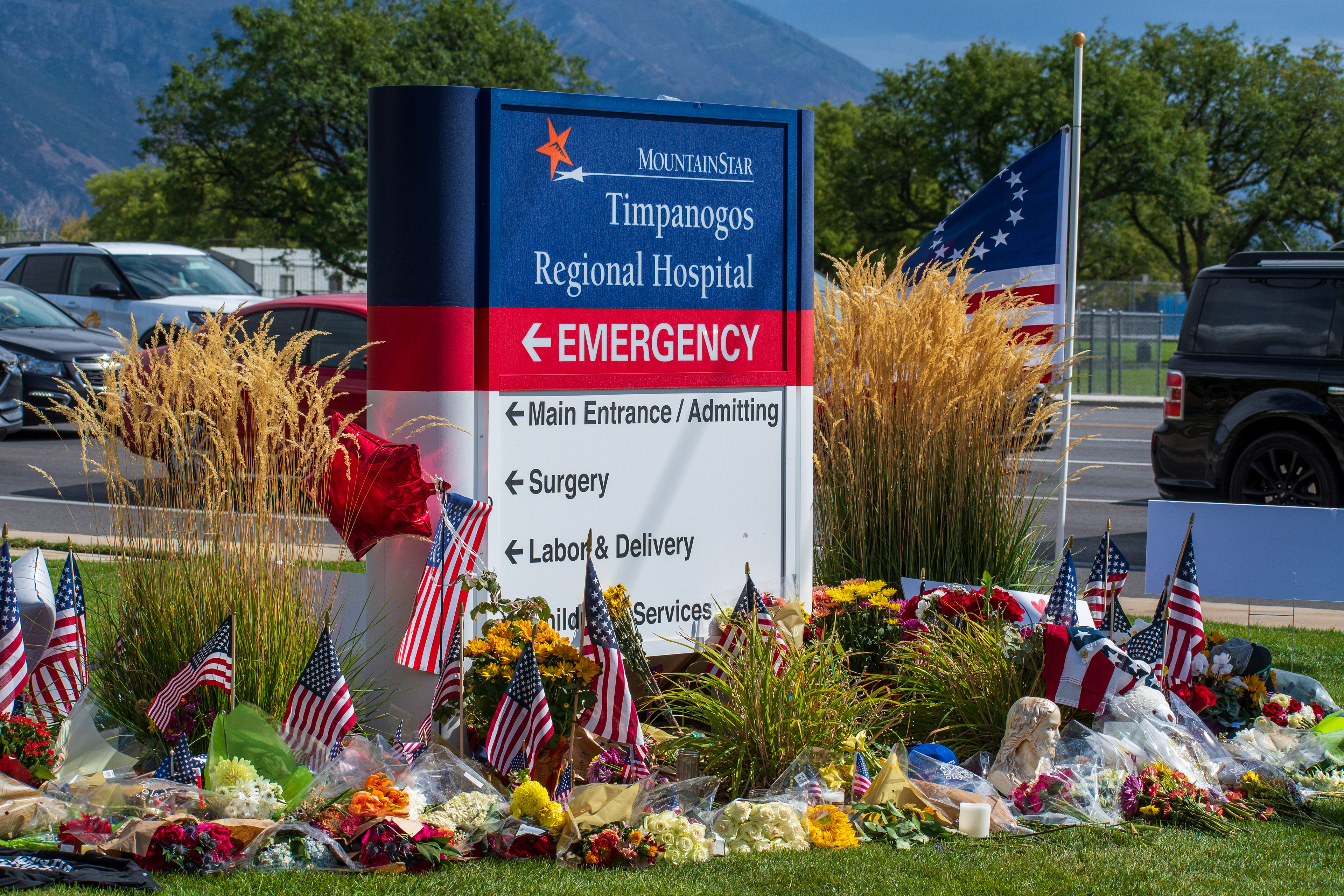 OREM, UTAH – SEPTEMBER 12, 2025: A memorial site for Charlie Kirk is seen in front of the MountainStar Timpanogos Regional Hospital sign near the Emergency Room entrance. American flags, balloons, flowers, and decorative items are arranged on the grass beside the roadside. © Charles‑McClintock Wilson / ZUMA Press