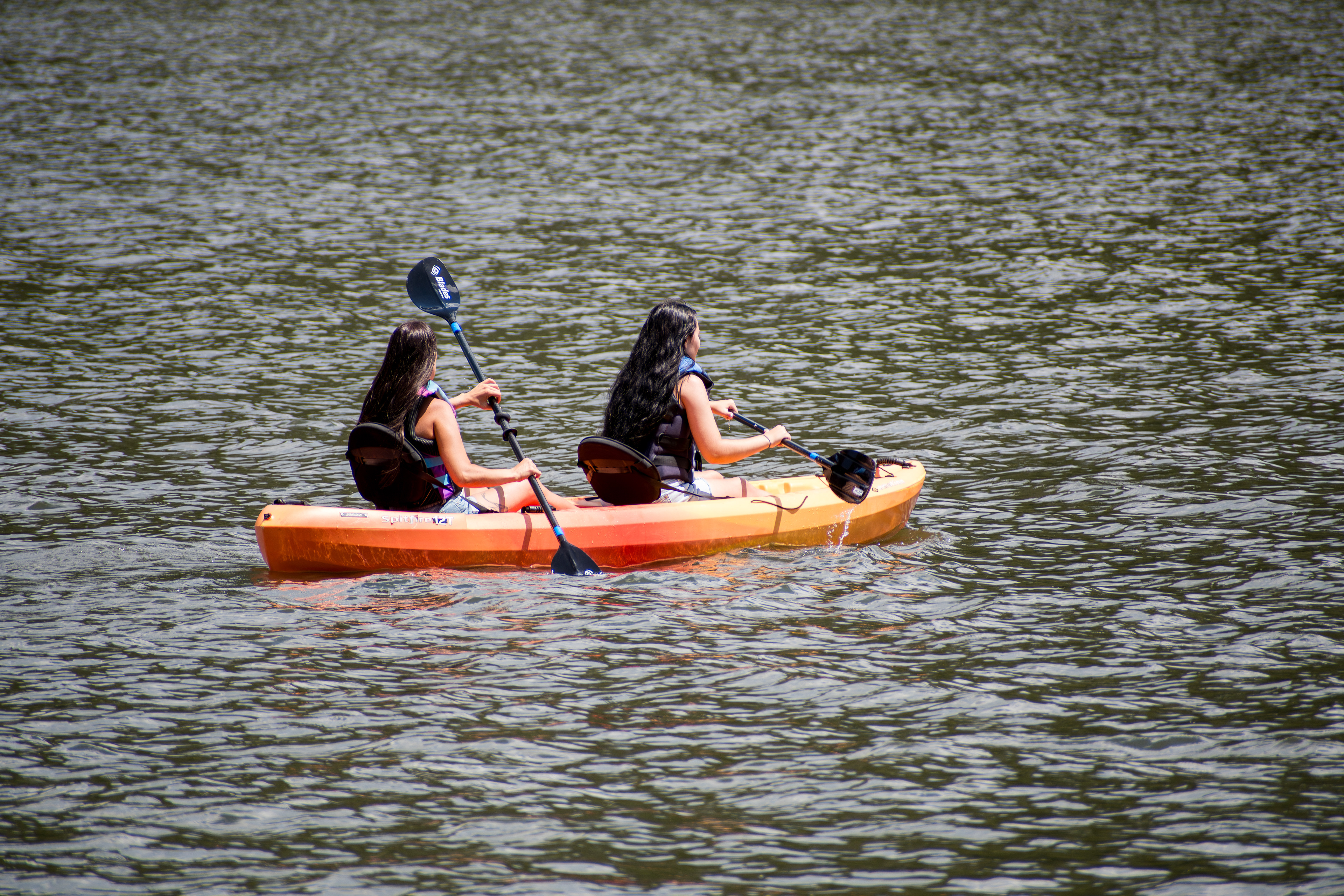 Summit County, Utah – July 20, 2025: People paddle kayaks across the calm waters of Smith and Morehouse Reservoir during a summer outing.