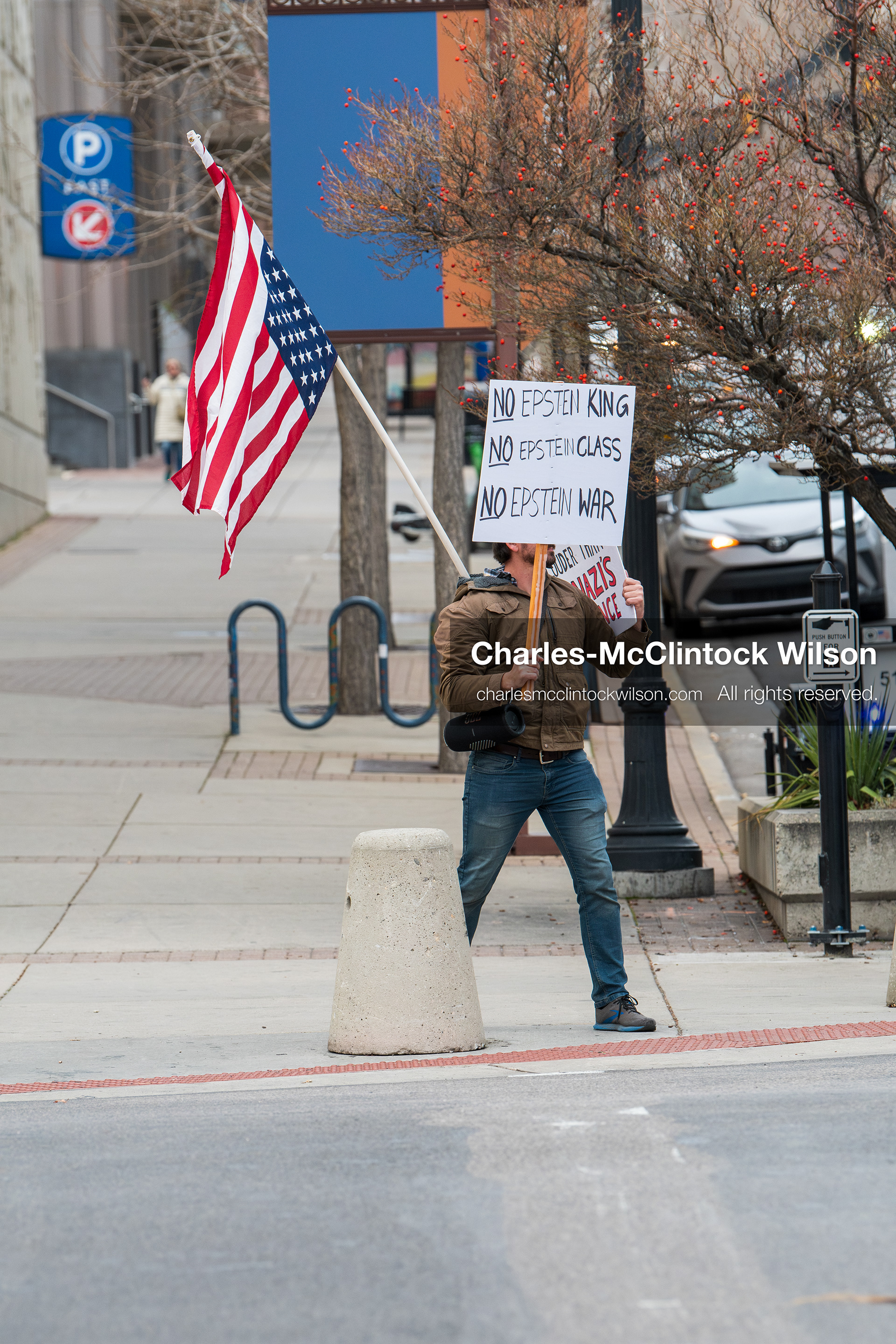 January 3, 2026, Salt Lake City, Utah, USA: A protester holds signs and an American flag during a demonstration against US action in Venezuela outside the Wallace Federal Building in Salt Lake City, Utah. The protest was part of a nationwide mobilization responding to recent military developments. (Credit Image: (c) Charles‑McClintock Wilson/ZUMA Press Wire)