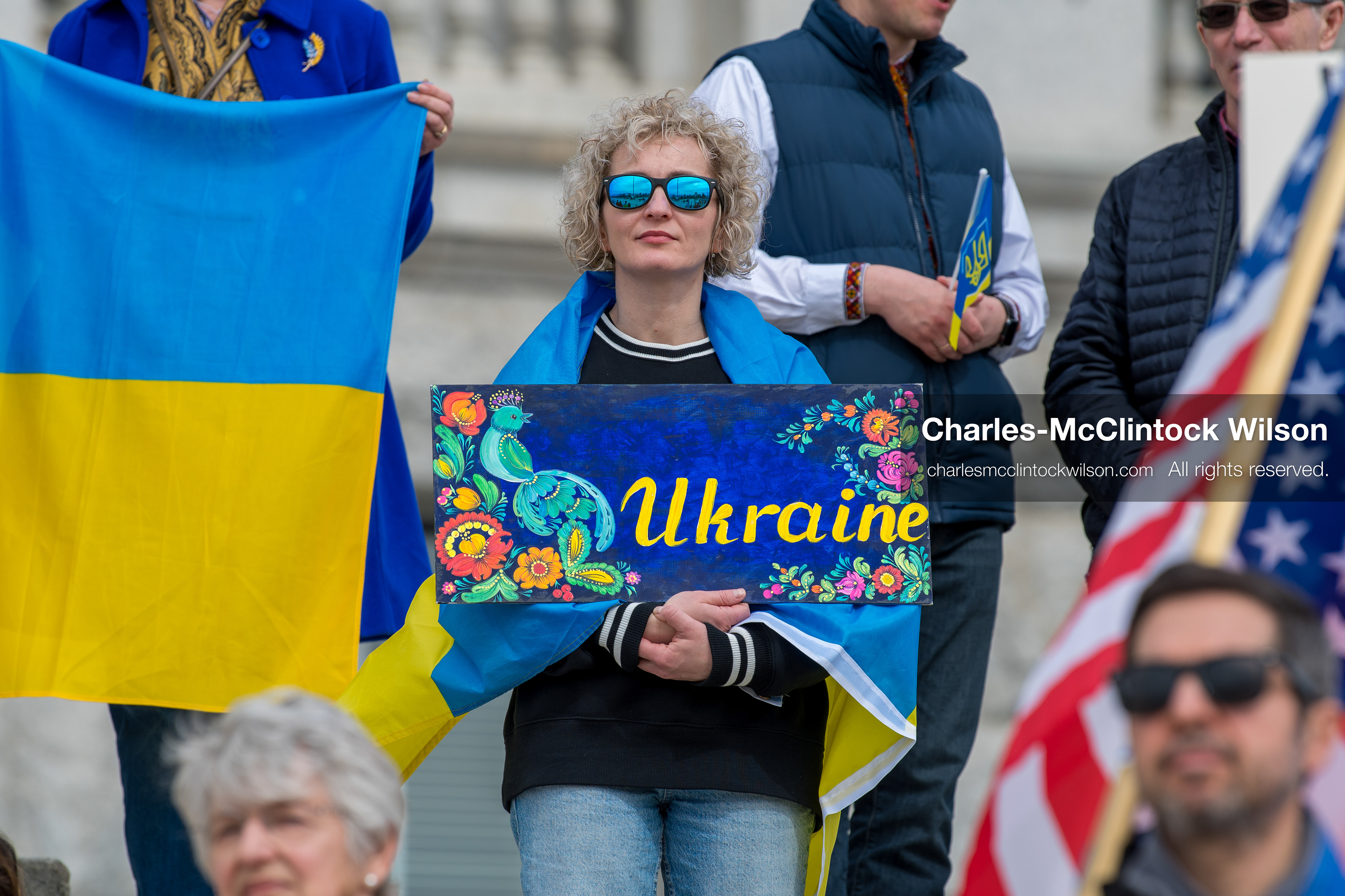 February 28, 2026, Salt Lake City, Utah, USA: A demonstrator draped in a Ukrainian flag holds a hand painted sign reading Ukraine during the Stand With Ukraine rally at the Utah State Capitol. The gathering marked the four year anniversary of the full scale Russian invasion of Ukraine and brought community members together in support of Ukrainians and local humanitarian efforts. (Credit Image: © Charles McClintock Wilson/ZUMA Press Wire) 