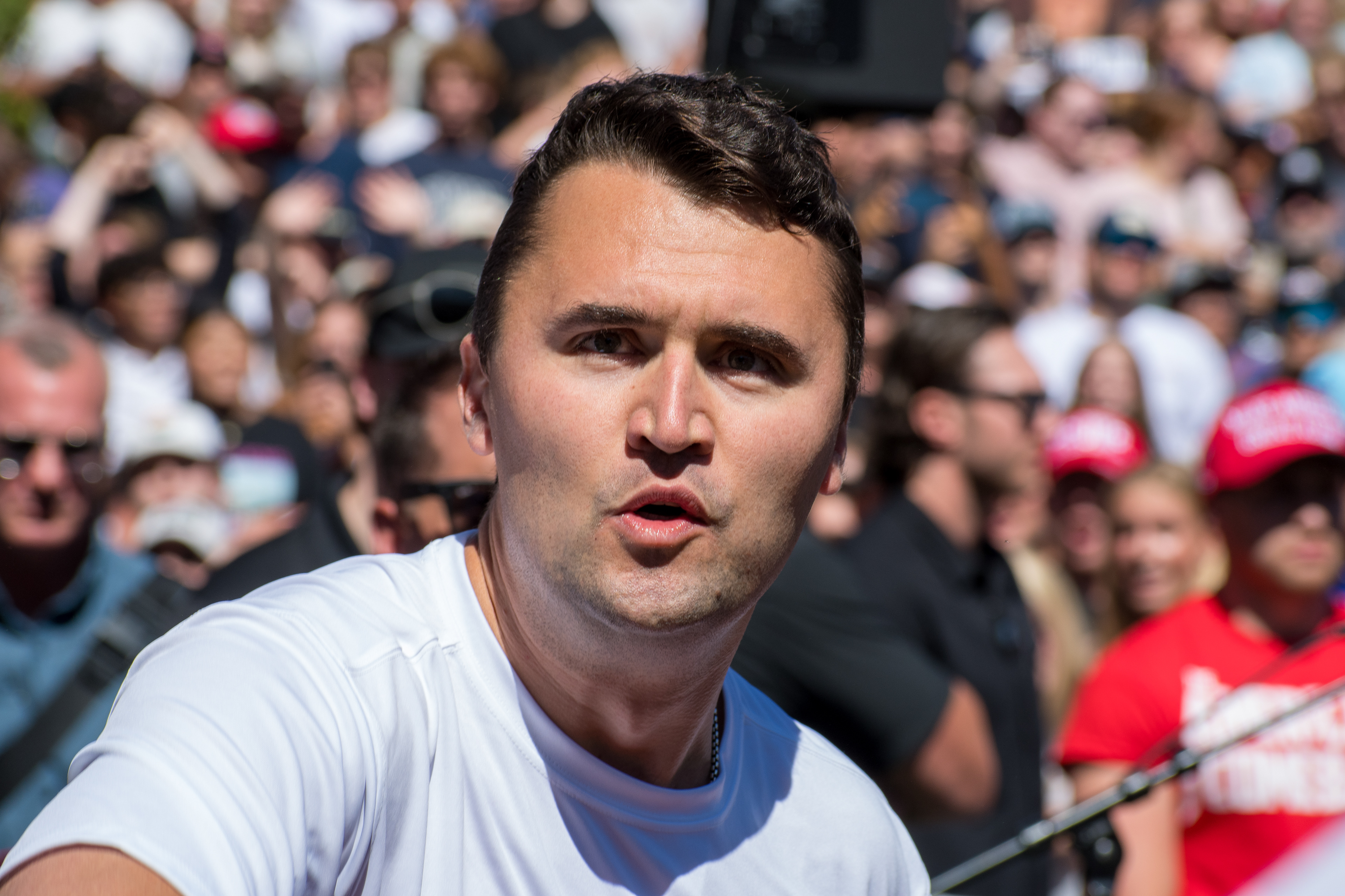 OREM, UTAH – SEPTEMBER 10, 2025: Charlie Kirk speaks with attendees during a public event at Utah Valley University. Positioned near a promotional booth and surrounded by supporters, Kirk appears engaged and expressive in one of his final public moments. The image reflects the atmosphere of direct outreach and energized dialogue that defined the gathering. © Charles-McClintock Wilson / ZUMA Press