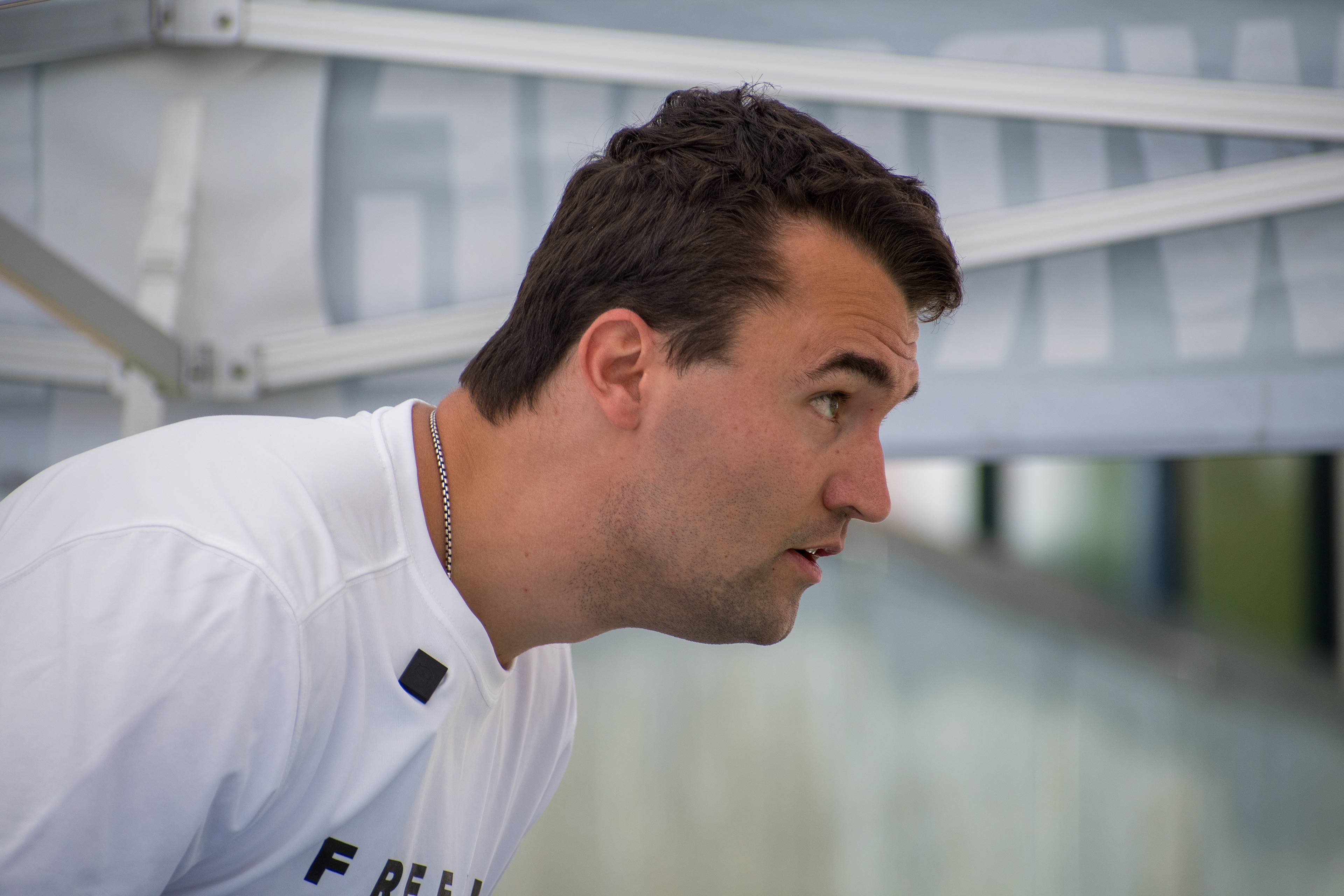 OREM, UTAH – SEPTEMBER 10, 2025: Charlie Kirk gestures while speaking to supporters during a public event at Utah Valley University. Captured mid-discussion beneath a canopy structure, Kirk appears animated and engaged as attendees listen closely. The image reflects a moment of active dialogue and conviction during his final public appearance before the shooting incident that disrupted the gathering. © Charles-McClintock Wilson / ZUMA Press