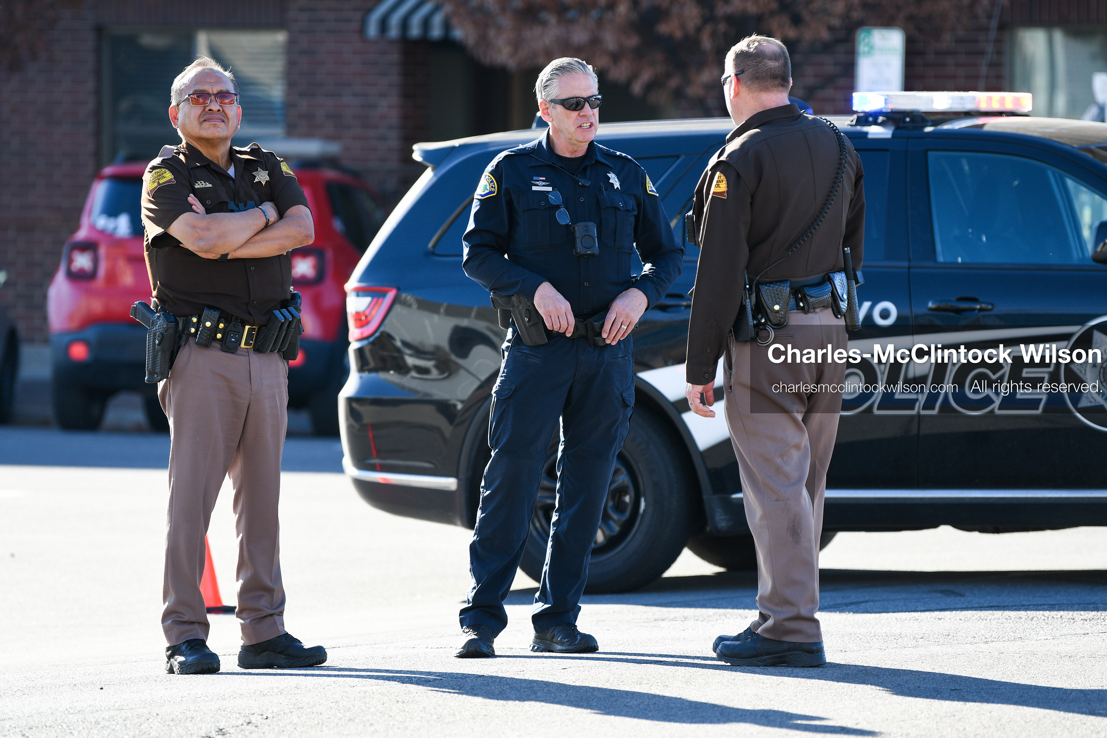 PROVO, UTAH, USA – DECEMBER 11, 2025: Two Utah Highway Patrol officers and a Provo Police officer converse outside the Fourth District Court in Provo during the first in‑person court appearance of Tyler Robinson in the Charlie Kirk murder case. (Credit Image: © Charles‑McClintock Wilson/ZUMA Press Wire)